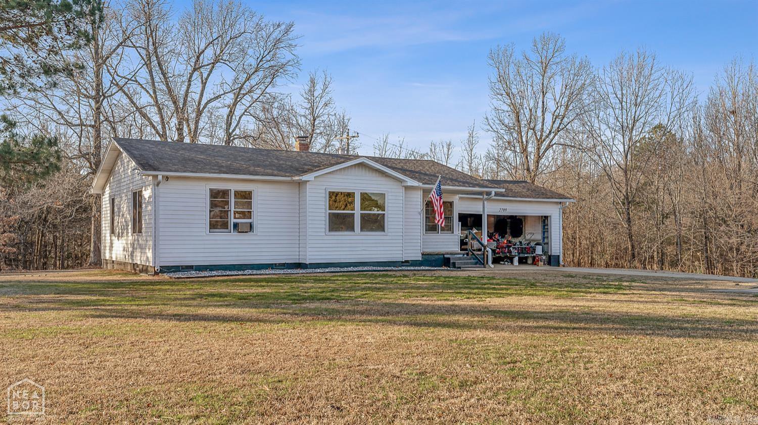 Country living with room to stretch out! Solid home that has had lots of updates but has still maintained its previous vintage charm. Original hardwood floors run through the dry rooms and have been refinished with a dark walnut stain that adds to the charm. The kitchen and one full bath have had lots of updates including modern gorgeous black marbled tile to go along with the black cabinets. The kitchen has an updated backsplash, stove, countertops, plumbing & farm sink. The main bath has new tile tub surround, new sink and toilet, lighting and plumbing. The Living Room has a gorgeous electric fireplace surrounded by floor to ceiling white shiplap. This home looks good but is also very functional for country style living. If, after a day of 4 wheeling and playing outside, you need a shower you can just step into the shower/toilet area of the laundry room and never have to dirty up the house. Storage? you will have ample space in the large laundry room, the extra storage room, and also in the unfinished basement. With a full price offer, seller will pay $7,000 to have central HVAC installed after closing. This cutie sits on approx 1 acre +/- with more land available for purchase. T