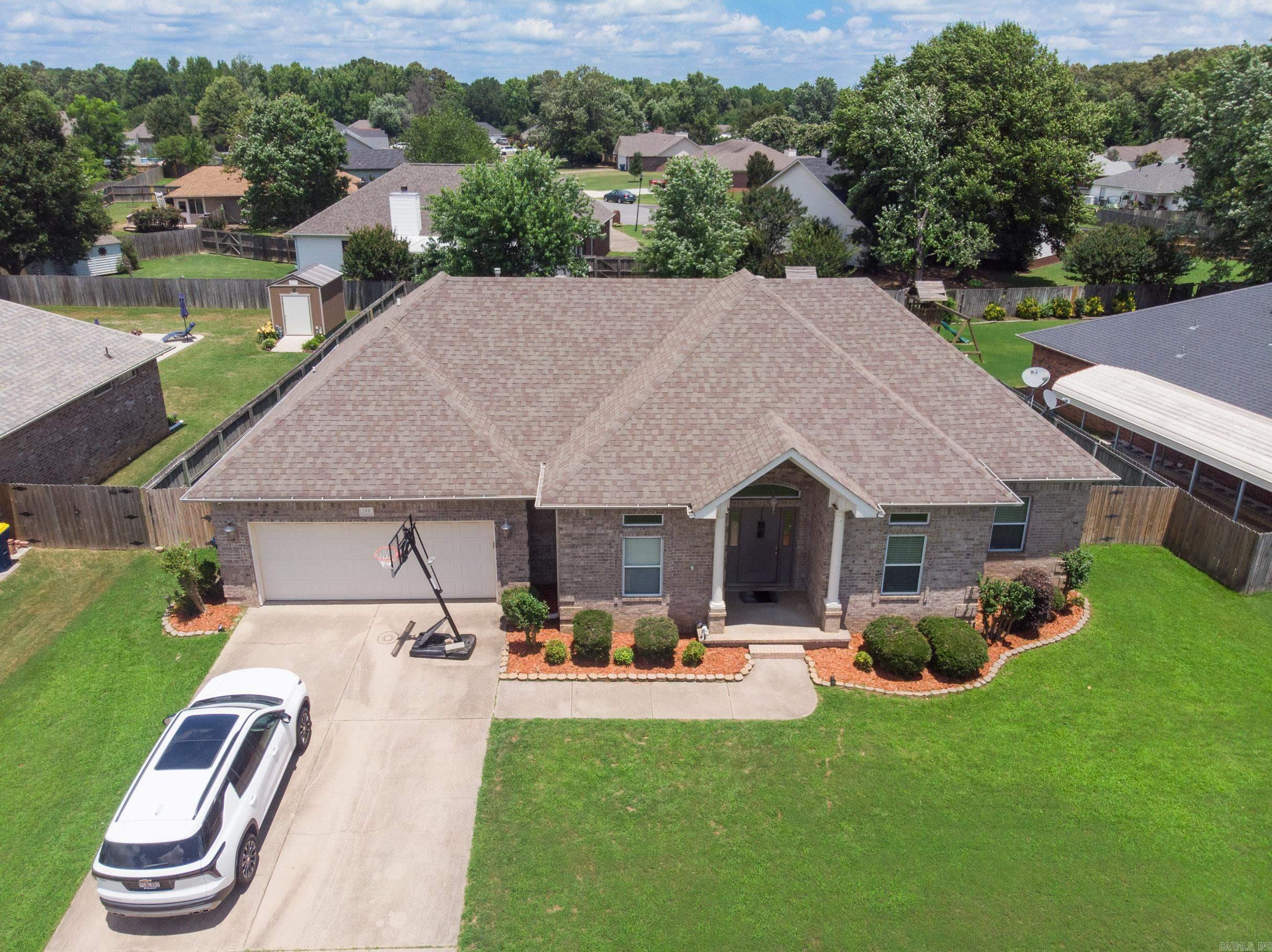 Looking for the perfect place for you and your family to call home? Look no further! 145 Birchwood Circle is so cozy! Walk in to the foyer with hardwood floors that lead you into the formal dining room or into the grand living area! Kitchen features stainless steel appliances, subway tile backsplash, granite countertops a breakfast nook! The split floor plan features the primary suite and laundry room off of the kitchen boasting a tray ceiling, with crown molding, separate soaker tup and shower, and a large primary closet! Off the living room and into the hallway you will find 3 bedrooms and a separate bathroom for the kids or guests to enjoy! For ultimate safety and comfort, there is a storm shelter in the garage! The back yard is fenced with a beautiful covered patio for entertaining, beautiful green grass and mature trees for extra shade and privacy! All of this tucked in a quiet subdivision close to town! Welcome to 145 Birchwood! Welcome home!