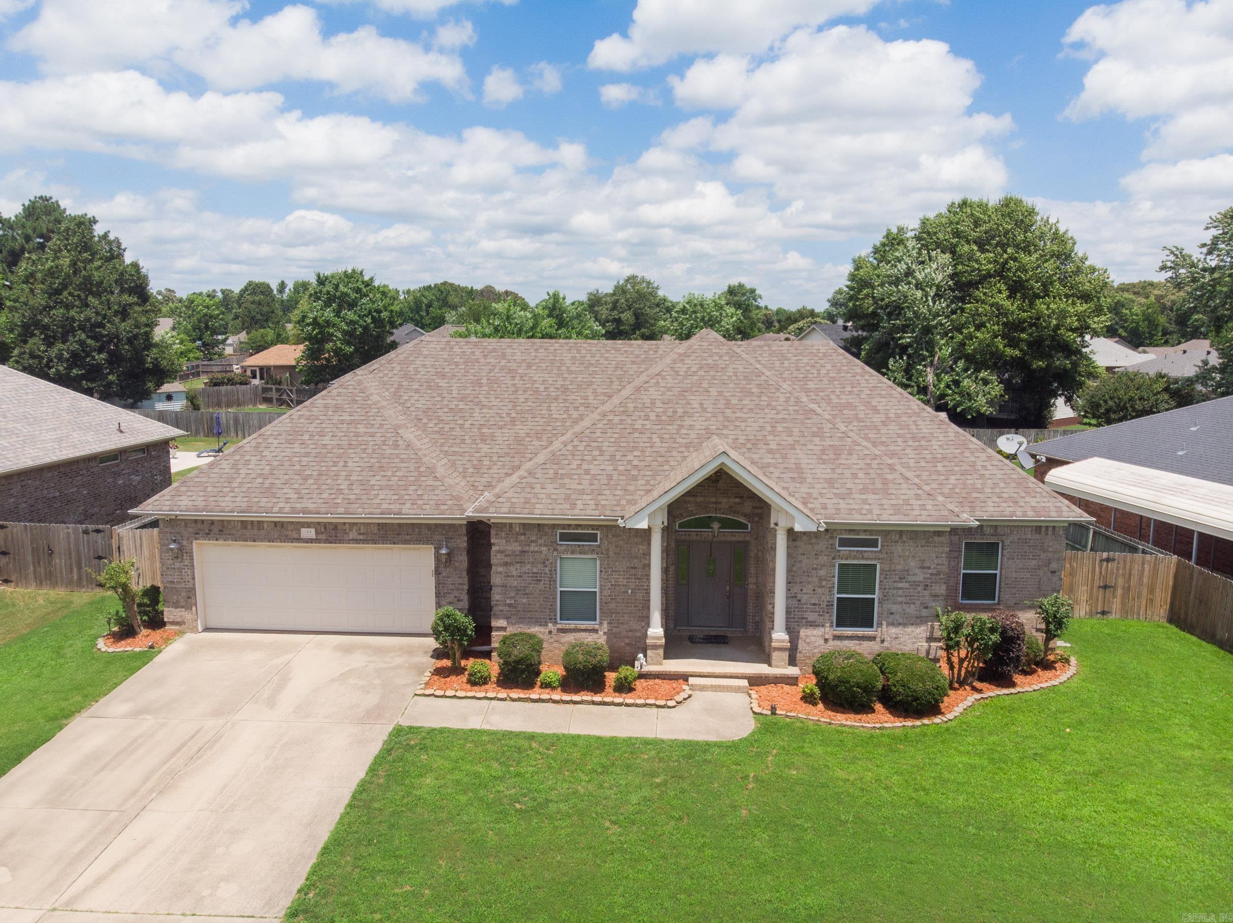 Looking for the perfect place for you and your family to call home? Look no further! 145 Birchwood Circle is so cozy! Walk in to the foyer with hardwood floors that lead you into the formal dining room or into the grand living area! Kitchen features stainless steel appliances, subway tile backsplash, granite countertops a breakfast nook! The split floor plan features the primary suite and laundry room off of the kitchen boasting a tray ceiling, with crown molding, separate soaker tup and shower, and a large primary closet! Off the living room and into the hallway you will find 3 bedrooms and a separate bathroom for the kids or guests to enjoy! For ultimate safety and comfort, there is a storm shelter in the garage! The back yard is fenced with a beautiful covered patio for entertaining, beautiful green grass and mature trees for extra shade and privacy! All of this tucked in a quiet subdivision close to town! Welcome to 145 Birchwood! Welcome home!