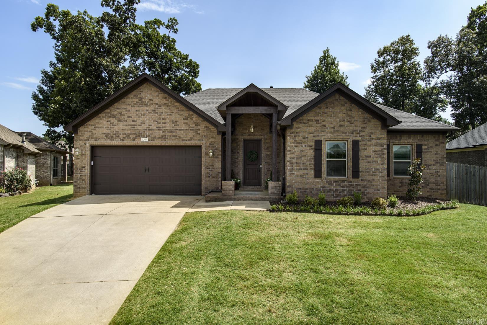 Enjoy the ease of one-level living in this beautifully maintained home tucked away on a cul-de-sac. Freshly painted throughout! The open-concept floor plan is designed for comfortable everyday living, featuring hardwood floors throughout the main living areas. A spacious living room with a gas log fireplace flows seamlessly into the eat-in kitchen, complete with stainless steel appliances (2024), a pantry, granite countertops and plenty of workspace for cooking and gathering. The split-bedroom layout provides privacy, with the primary suite offering new carpet, a large walk-in closet, and an en-suite bath. Two additional bedrooms and a full bath with double vanity sinks are thoughtfully located on the opposite side of the home. A separate laundry room adds everyday convenience, while the covered back porch and fenced backyard create the perfect space to relax or entertain. Roof replaced in 2024. Complete with a two-car garage, this move-in ready home offers comfortable, low-maintenance living. Agents, please see remarks.