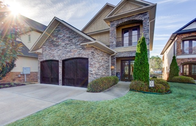 Luxury lake living awaits you! This gorgeous home features 3 levels of upscale finishes, an elevator, custom wall treatments, granite throughout, a relaxing lakeside patio, 2 birds eye view decks with outside kitchen perfect for entertaining, a gourmet kitchen and 2 living areas. This dream home can be your reality! Most of the furnishings to convey!
