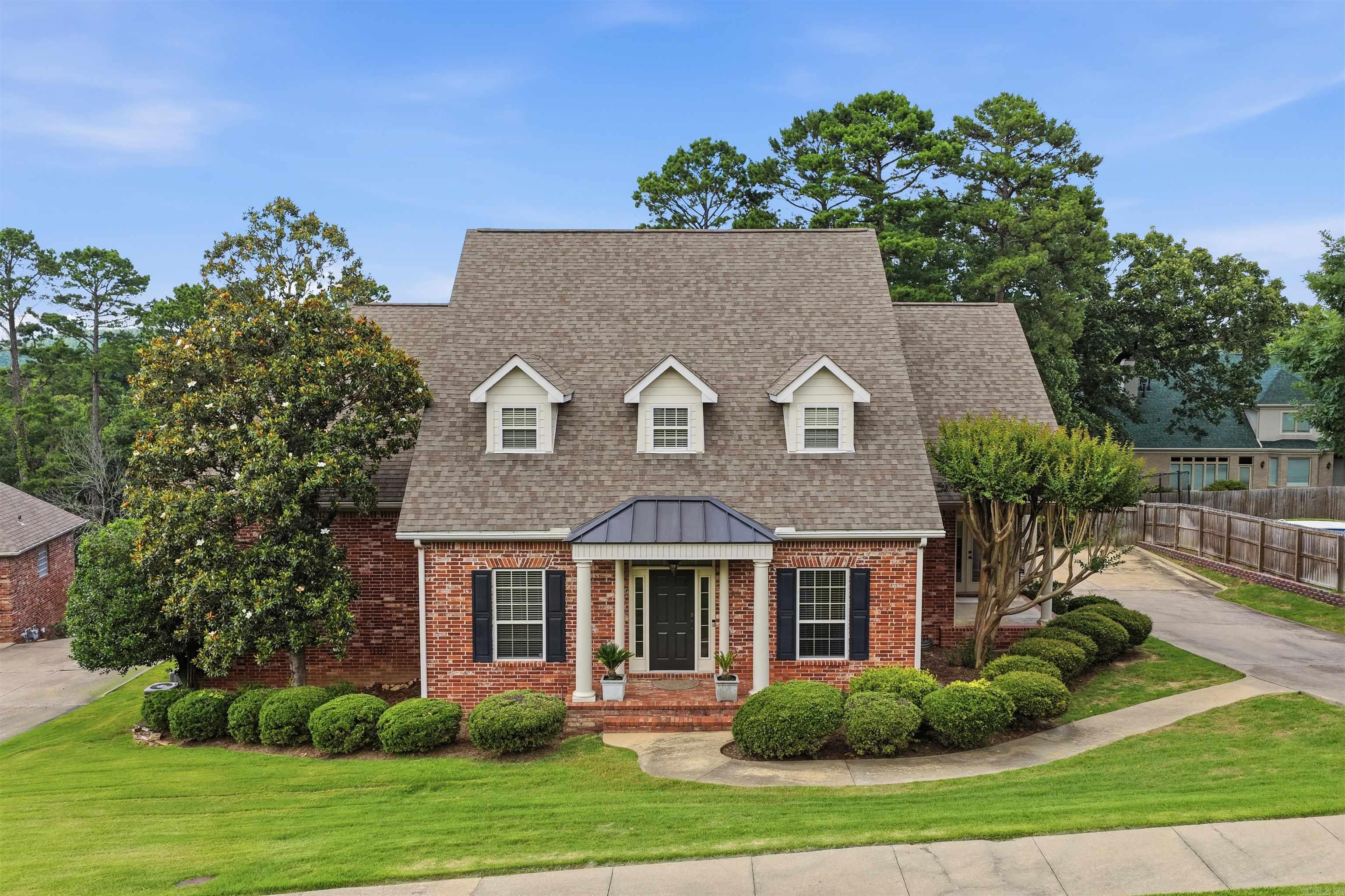 Welcome to 22 Bayonne Court, nestled in a quiet cul-de-sac within Chenal Valley's Bayonne Place. This brick and Masonite siding home offers a thoughtfully defined floor plan with site-finished oak hardwood floors throughout the main level. The entry flows to a formal dining room and private office with French doors. The great room centers around a gas fireplace with custom built-ins; the kitchen features a KitchenAid gas cooktop, wall oven, microwave, dishwasher, warming drawer, Corian countertops, center island, and built-in desk. A sunlit breakfast area opens to a covered side porch and a mudroom with sliding barn door. The main-level primary suite includes a spa-like bath with dual vanities, jetted tub, walk-in shower, and private water closet. Upstairs offers a game room/den, two additional bedrooms with a shared bath, a 4th bedroom, hall bathroom and laundry room. The back deck overlooks a fully fenced backyard with mature trees. Additional highlights: fresh interior paint, irrigation system, and 3-car side-load garage. Neighborhood pool and park are located just around the corner - offering all the perks, none of the maintenance!
