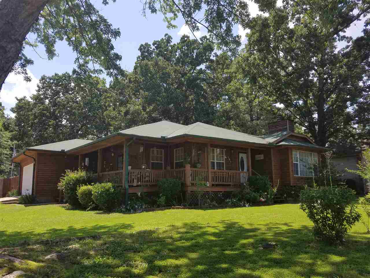 LOADS OF CURB APPEAL with this conveniently located 3 bed / 2 bath, 1600 sf home with lots of extras including updated kitchen with new stainless appliances, hand scraped wood floors, dining area, office, laundry room, 2 storage buildings.  Trane HVAC.  Great covered porch wrapping halfway around home.