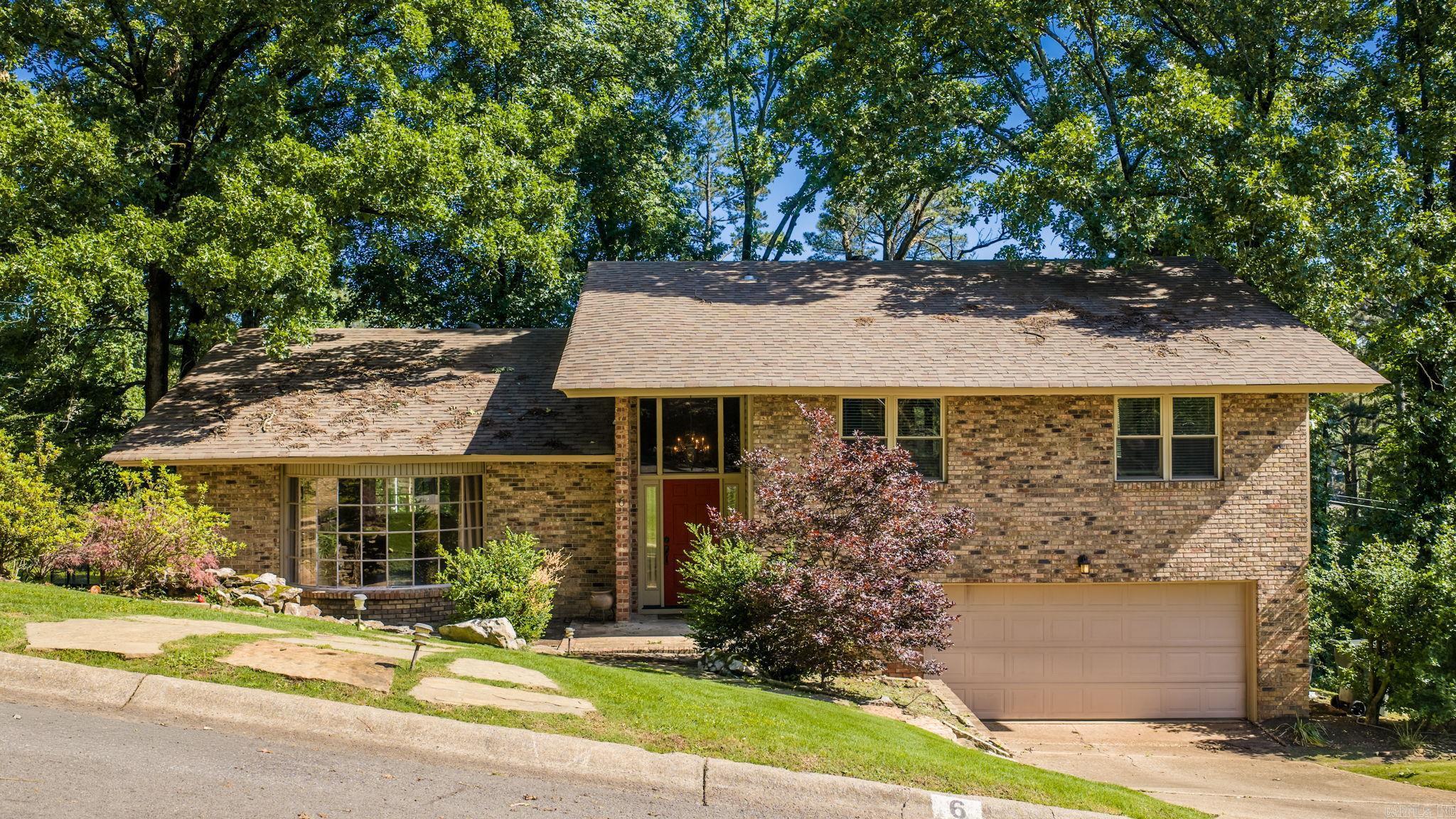 Escape to this Tree house in the heart of Leawood. Flagstone steps welcome you to the water feature at the front door. Short commute to UAMS, and shopping/dining. Traditional Split level with hardwood floors & tile (no carpet) Windows, roof and updates all completed in last 6-8 years. Multi tier deck overlooks the tree lined landscape, w/flat area w/playset. Kitchen, dining & living all semi open concept, with granite countertops & stainless steel appliances.