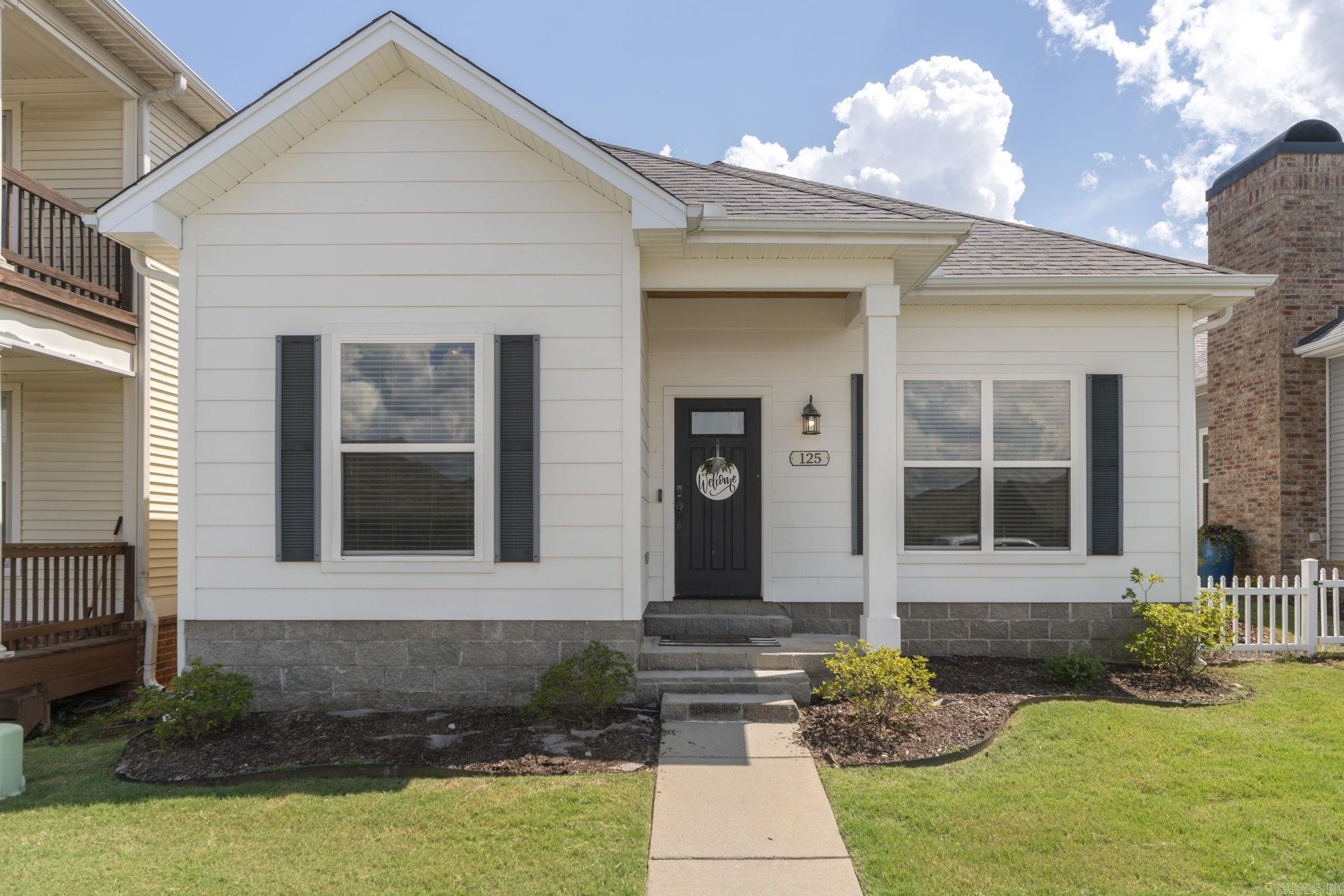 Welcome to The Villages at New Bedford in Maumelle! Built in 2016, this sleek, stylish, and immaculate 3-bedroom, 2-bathroom patio home is packed with high-end finishes and modern design throughout.  Step inside the inviting entry and feel the grandeur of 10-foot ceilings and gorgeous wood floors that tie the living spaces seamlessly together. The open-concept living room boasts stunning beamed ceilings and a cozy fireplace, flowing effortlessly into a chef’s kitchen equipped with premium granite countertops, high-end appliances, a spacious breakfast bar, and a roomy pantry.  Directly adjacent to the kitchen is a bright and welcoming eat-in dining space, creating the ultimate open layout for casual family meals and effortless entertaining.  Retreat to the expansive primary suite featuring a spa-like bath for ultimate relaxation. Outside, the lovely covered back porch offers a peaceful, shaded oasis to unwind. Enjoy low-maintenance patio living at its absolute finest!  Don't wait—this gem won't last long. Call today to schedule your private showing!