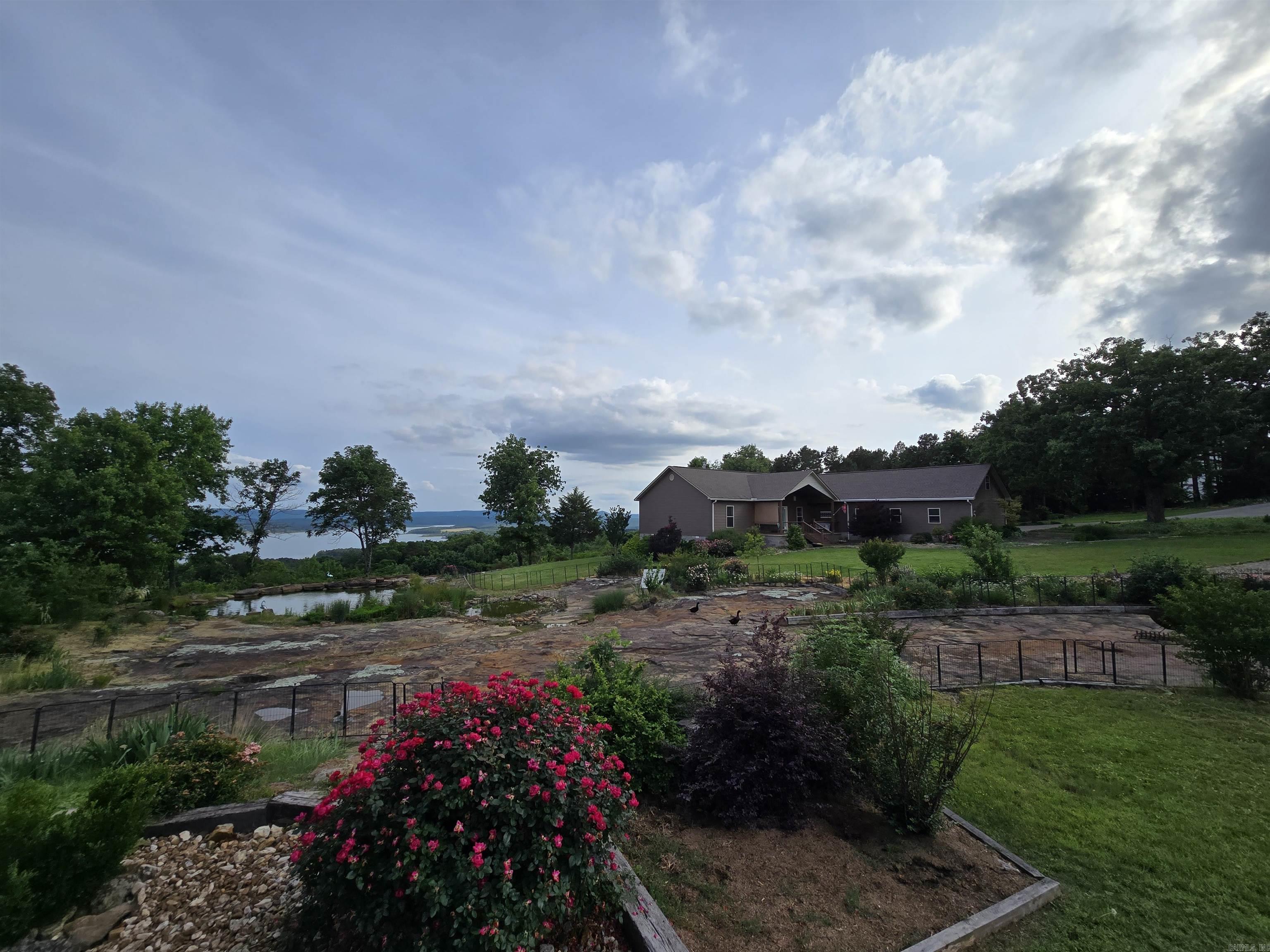 Here is your chance to own a very rare property with one of the very best lake views on Greers Ferry Lake.  This little description and few photos do it no justice.  If you're in the market for something like this, go look at everything else first, then come see this.  There is nothing better.  Situated on 5.19 fenced unrestricted acres with expansive views right through the Narrows bridge from every room of the 2492ft² 3 bedroom, 3 bath custom main home with with large open living area, cooks kitchen, large pantry, laundry/sewing room, over-sized 2 car garage with professional dog washing station, walkout master bedroom, large covered back deck, loads of smart storage, perfectly clean and move-in ready. if you need more space, there is also a 30'x100' shop with side entry and RV doors and a 1500ft² 2 bedroom, 1.5 bath guest house inside that also has one of the best lake views on this lake as well as overlooking the thriving koi pond built into an unbelievable rock formation.  Gated entry from Irish Hills and Edgemont roads.  This is the opportunity of a lifetime.  Call today to schedule your private showing this weekend.