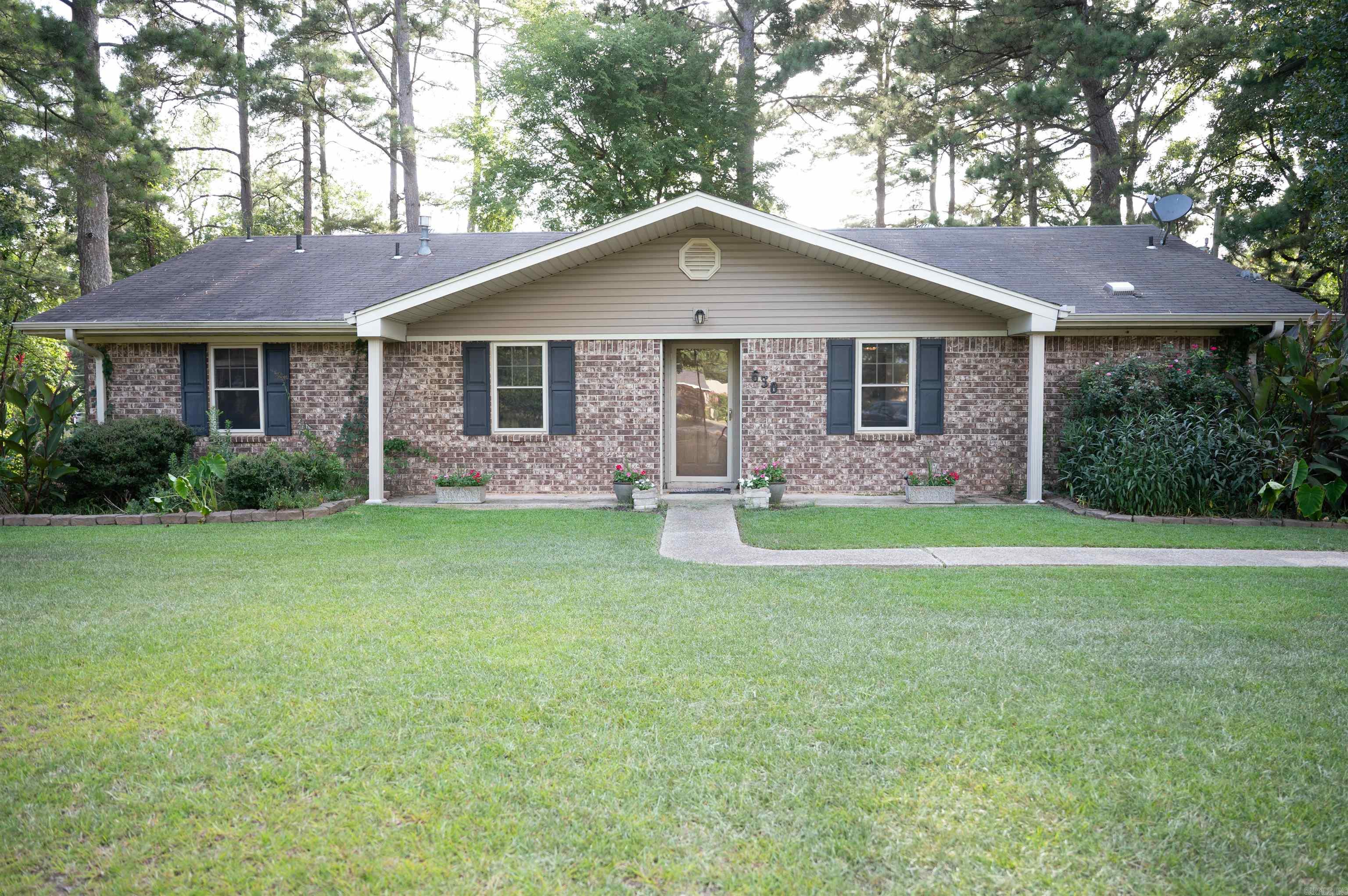 Welcome home to this lovely 3-bedroom, 1.5-bathroom classic brick ranch style tucked away in Monticello's desirable Parkwood subdivision! Offering excellent curb appeal, a spacious front yard, and mature shade trees, this home blends timeless charm with modern convenience.  Spacious Living & Dining: Updated wood-look flooring and light, airy paint colors create a bright, inviting atmosphere in the main living space.  Warm Kitchen: Plenty of cabinetry for storage, stainless steel/black appliances, tile backsplash, gas range cooktop, and a convenient breakfast bar/counter area. Refrigerator stays.   Dedicated Laundry Room: Includes wainscoting details and built-in upper cabinets for extra storage. Washer & dryer stay.   Outdoor Space: Enjoy a private, pine-shaded backyard complete with a fire pit ring and a large outdoor storage shed/barn with an attached lean-to overhang—perfect for extra equipment or workshop space. Windows replaced within past 10 years. Kitchen remodeled, new AC & office added in 2020.  An ideal fit for first-time buyers, downsizers, or anyone looking for a well-maintained home in a quiet community. Schedule your showing today!