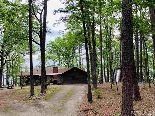 One of the last great main channel points on beautiful Lake Hamilton with Northern and Eastern views. Virgin timber for the perfect estate-sized home or 5 beautiful lots. There is a 1940's cottage on the lakefront, but value is in the land.