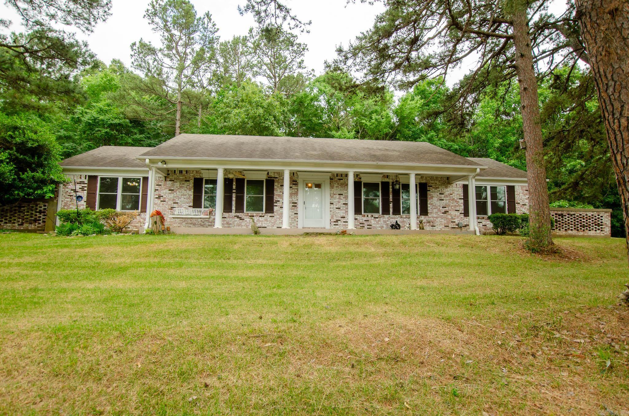 Tucked away on 1.4 acres near the Paragould Country Club, this classic brick ranch offers the kind of space and setting that's hard to find. Wake up to peaceful pond views, enjoy evenings by the brick fireplace, and spread out with two separate living areas perfect for entertaining or everyday life. The updated primary bathroom adds a fresh touch, while newer windows bring in beautiful natural light throughout the home. Need extra space? The finished attic offers tons of storage, and the detached accessory building with living quarters, kitchen, and full bath opens the door for guests, a home office, or rental potential. With a 2-car garage, storage closets, and room to breathe both inside and out, this property blends comfort, flexibility, and country club-area charm in one inviting package.