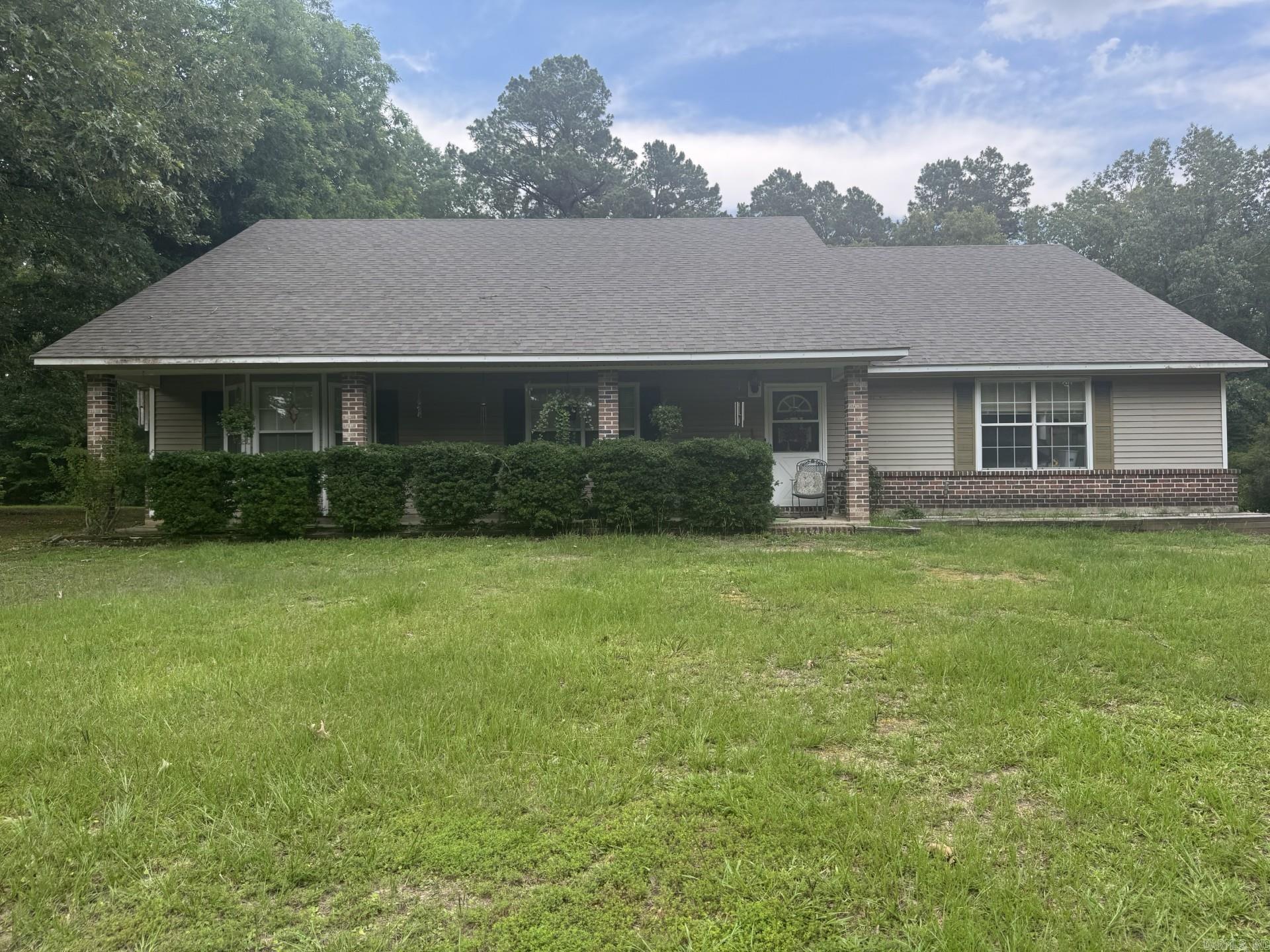 Are you looking for a home in the country?  Nestled in the peaceful countryside of Fordyce, this charming rural retreat offers the perfect blend of privacy, comfort, and country living. Situated on 4.52 acres nearly 2,000 sq ft of living space. Traditional style is a combination of brick and siding. Brand new roof, 4th bedroom, could be used as a sun room.The acreage offers a mix of cleared & wooded land creating plenty of room for outdoor recreation, gardening, livestock, includes a large shop.
