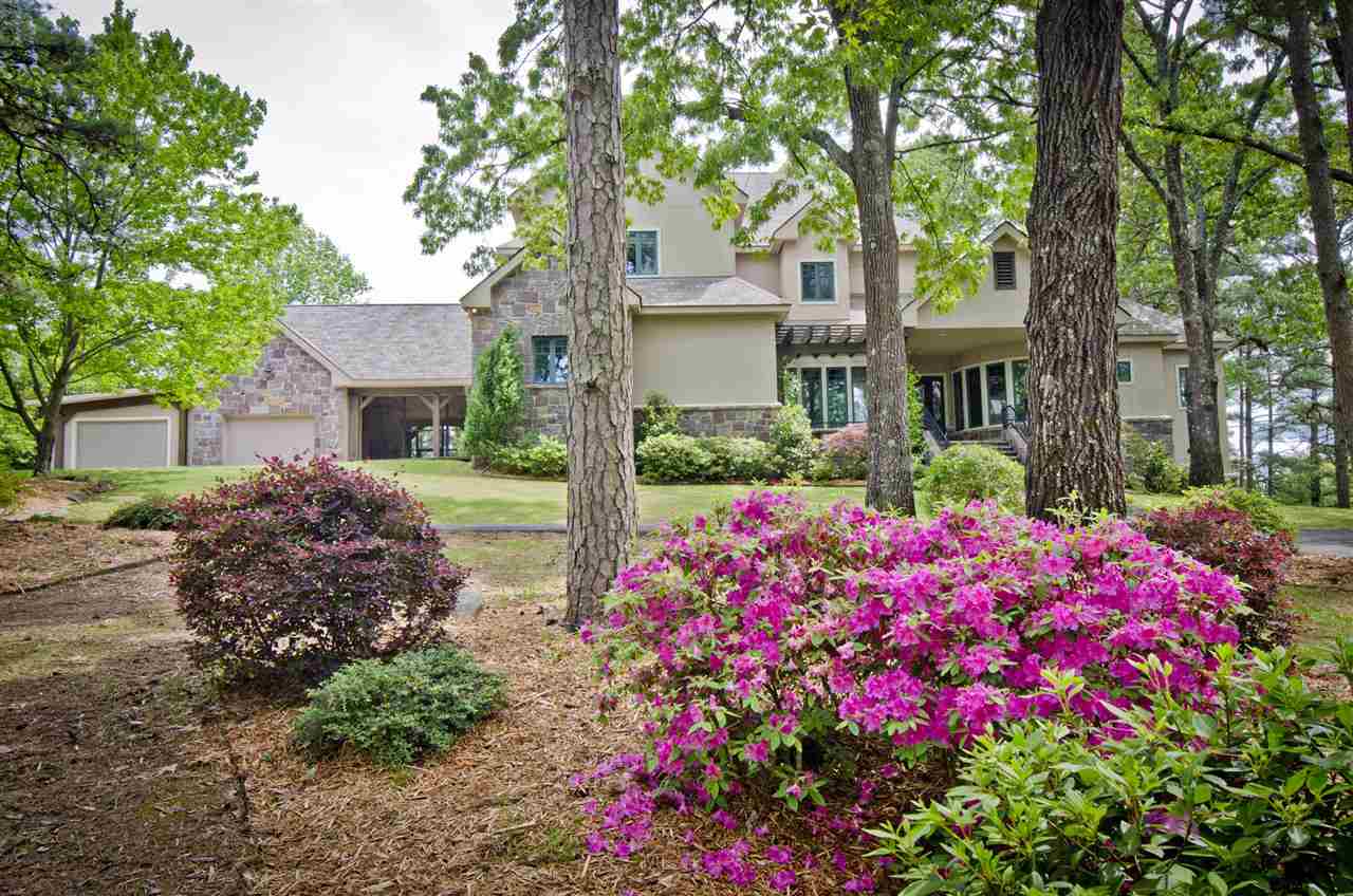 GORGEOUS doesn't even begin to describe this private home full of masterful design details, pristine acreage and 4,233 sq ft in one of Hot Springs' most sought after areas.  Beautiful stone/stucco facade and mature trees surround this 4 bedroom 3 1/2 bath custom home.  Only the finest design finishes in this large chef's kitchen with over sized island, stainless appliances and custom cabinetry.  The grand entry makes a memorable first impression with custom details including Pecky Cypress used throughout.