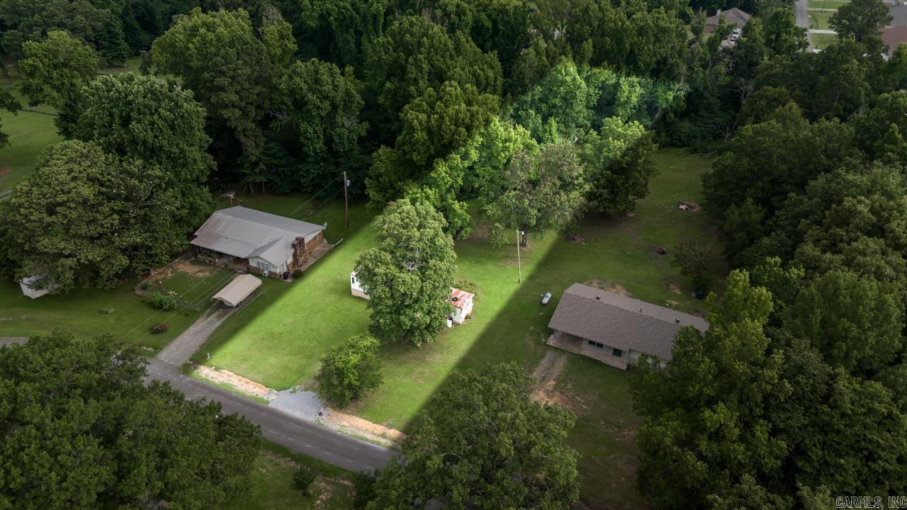 Opportunity awaits on this beautiful 1-acre homesite just minutes from Lake Conway! Nestled among mature trees in a peaceful country setting, this property includes an existing 2-bedroom, 1-bath mobile home and offers endless potential for investors, builders, or buyers looking for an affordable project.  Whether you choose to renovate the existing home, replace it with a new manufactured home, or explore building your dream home, the value is in the land, utilities, and exceptional rural location.  Enjoy easy access to Lake Conway for fishing, boating, kayaking, and outdoor recreation while remaining conveniently located near Conway with an easy commute to Little Rock.  Property is being sold AS IS, WHERE IS. Existing septic system is included, but its condition and capacity are unknown and will not be tested by the seller. Buyers are encouraged to conduct any desired inspections.  Looking for additional space? The beautifully remodeled home on the adjoining 1-acre parcel at 4 Simmons Lane is also available, creating a rare opportunity to own approximately 2 acres.