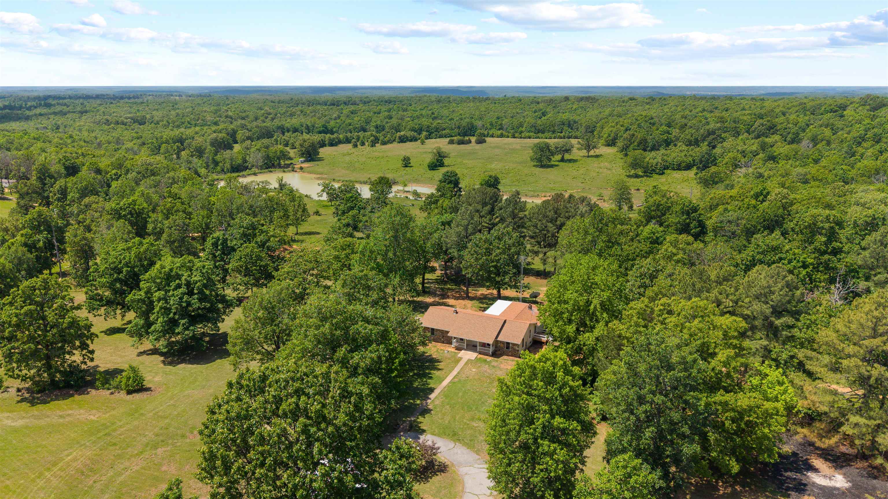 Welcome to 3555 Highway 167 in Ash Flat, Arkansas — a massive legacy estate hitting the market for the first time ever. Spanning 124 acres, this rare property blends open pastures, wooded hunting land, and three beautiful ponds, creating a one-of-a-kind setting for ranching, recreation, or building out your dream homestead. Completely fenced, the land offers room for horses, cattle, potential for an arena, or large-scale agricultural use, all while maintaining the privacy and serenity of a true country retreat. Yet despite its size and seclusion, the property sits right off Highway 167 and is just minutes from Ash Flat — the best of convenience and countryside in one place. At the heart of the estate, past a massive blanket of Zoysia grass sits a 6-bedroom, 3-bath home in amazing, move-in-ready condition. Spacious, solid, and designed for real living, it’s perfectly positioned to overlook the acreage while staying tucked away like it’s miles into the country. Opportunities like this don’t come around often. New septic, new French drain, rural water with a well for backup and barn. A true Arkansas legacy property ready for its next chapter.