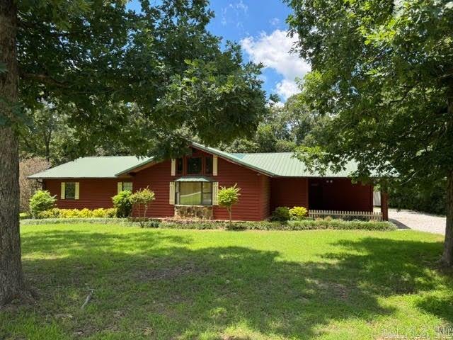 Charming cedar log home in Southside area with massive fireplace in middle of great room with gas logs. Home has pine flooring & some ceilings, both bathrooms have been updated, property has double garage and bald eagle barn plus back deck and fenced back yard, great for entertaining and relaxing! There is approx 340 sq ft of ADDITIOMAL space off entry where second laundry and another room is located for over 2000 sq ft of total space.