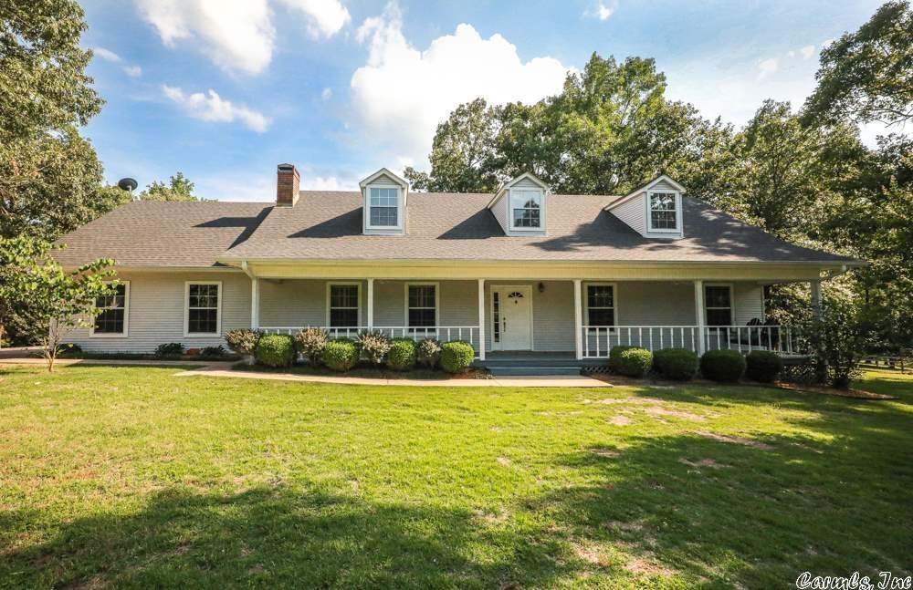 Woo hoo! Beautiful, recently updated home on 6 acres with a shop, inground pool, pond and cross fencing. Located in very pretty area of Tull with similarly nice homes on acreage. Recent updates include completely new kitchen with custom cabinets, granite counter tops, divided farm sink, 6x7 island with butcher block top, new Whirlpool appliances. The home has also been completely repainted and had new hardwood flooring installed. Bathrooms have been updated with new cabinets, granite counter tops, and lighting. Exterior updates include boundary fencing, cross fencing and new fencing around the pool, replaced decking and front porch as well. Shop is 24 x 40 and has heat, window air, and half bath.  The pool is 18 x 36 and has a deep end for diving!  Job transfer is the only reason the owners are selling. Let their move be your opportunity to purchase this lovely homestead. **Pictures of the pool and any photos with green grass are from a previous listing with the express permission of listing agent and provided by CARMLS**
