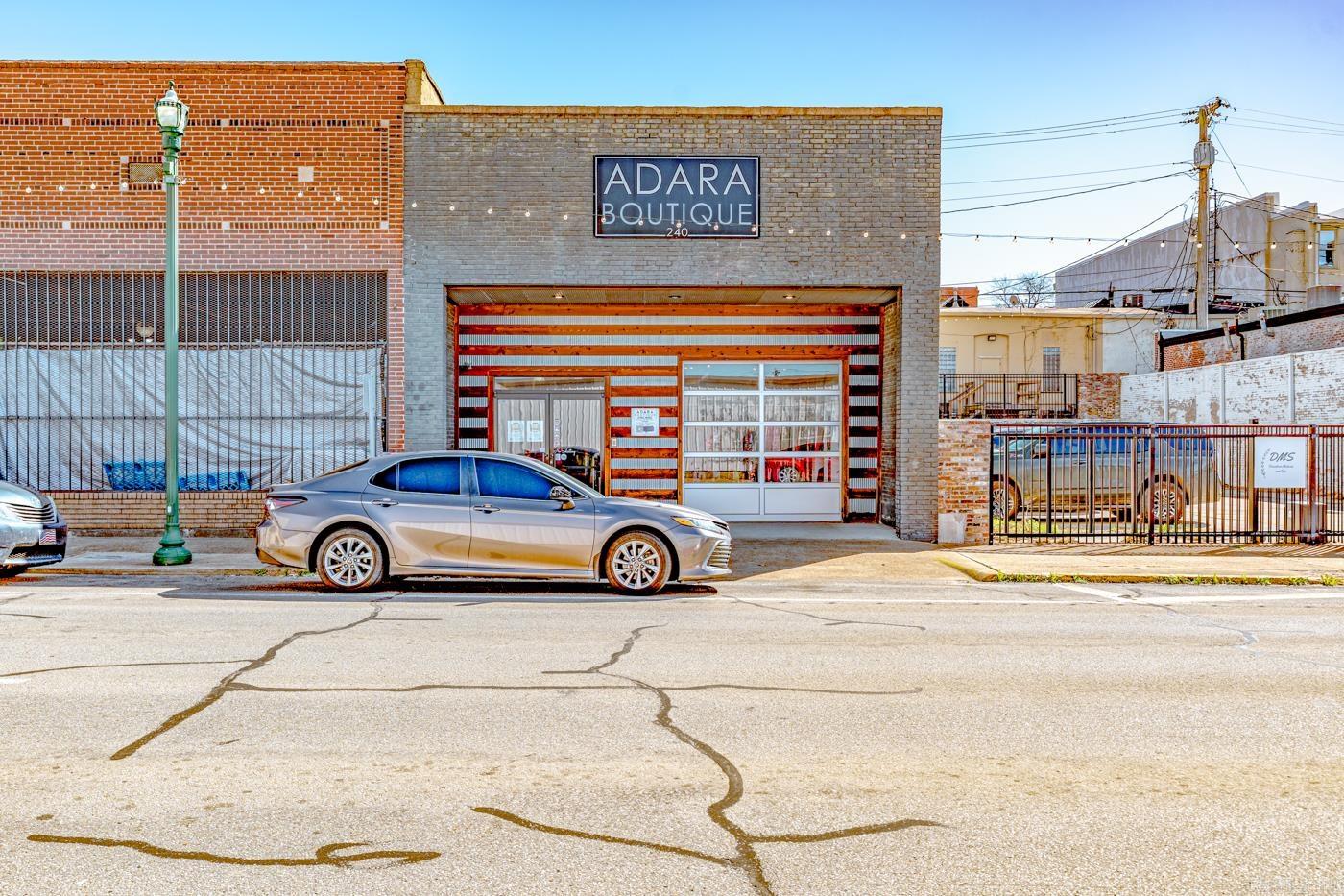 Welcome to the Market Adara Boutique located in the heart of downtown Jonesboro.      This commercial property features an open floor plan with exposed brick, an updated restroom, and industrial-style ceilings accented with antique ceiling tiles, modern fixtures, and contemporary lighting.   the building offers approximately 2,250 square feet of interior space and includes excellent frontage along Union Street, providing strong visibility and accessibility.       This listing is for the building and land. The current owner would sell the existing inventory, business name, and established wholesale vendor contacts separately for an additional negotiated price.