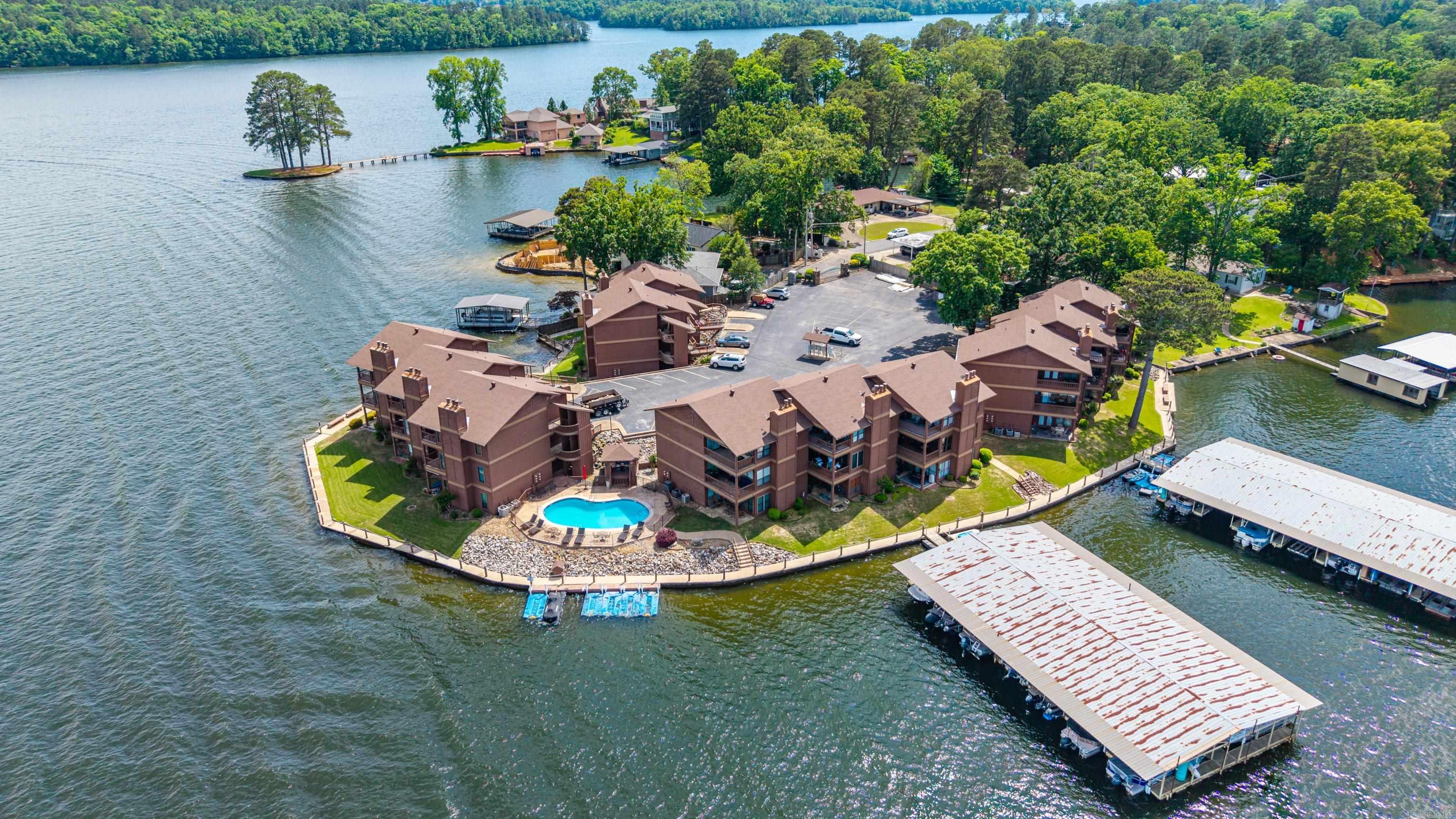 This stunning lakefront condo offers the perfect blend of convenience and relaxation with its sought-after walk-in entry. Step inside a fully furnished space where every detail has been handled, allowing you to start enjoying the water immediately. You can rest easy knowing the big-ticket items are updated, including a brand-new washer (2026) and a new HVAC system installed in 2023. Outside, your private jet ski pad provides instant access to lake adventures. The entire complex has been meticulously maintained, boasting recent upgrades like new roofs and sturdy modern staircases. You will especially love the resort-style atmosphere of the newly completed pool renovation, perfect for summer afternoons. Because short-term rentals are strictly prohibited, you are guaranteed a quiet, stable environment focused on peaceful year-round living. Best of all, you are just minutes away from local shopping, dining, and entertainment, putting you close to everything Hot Springs has to offer.