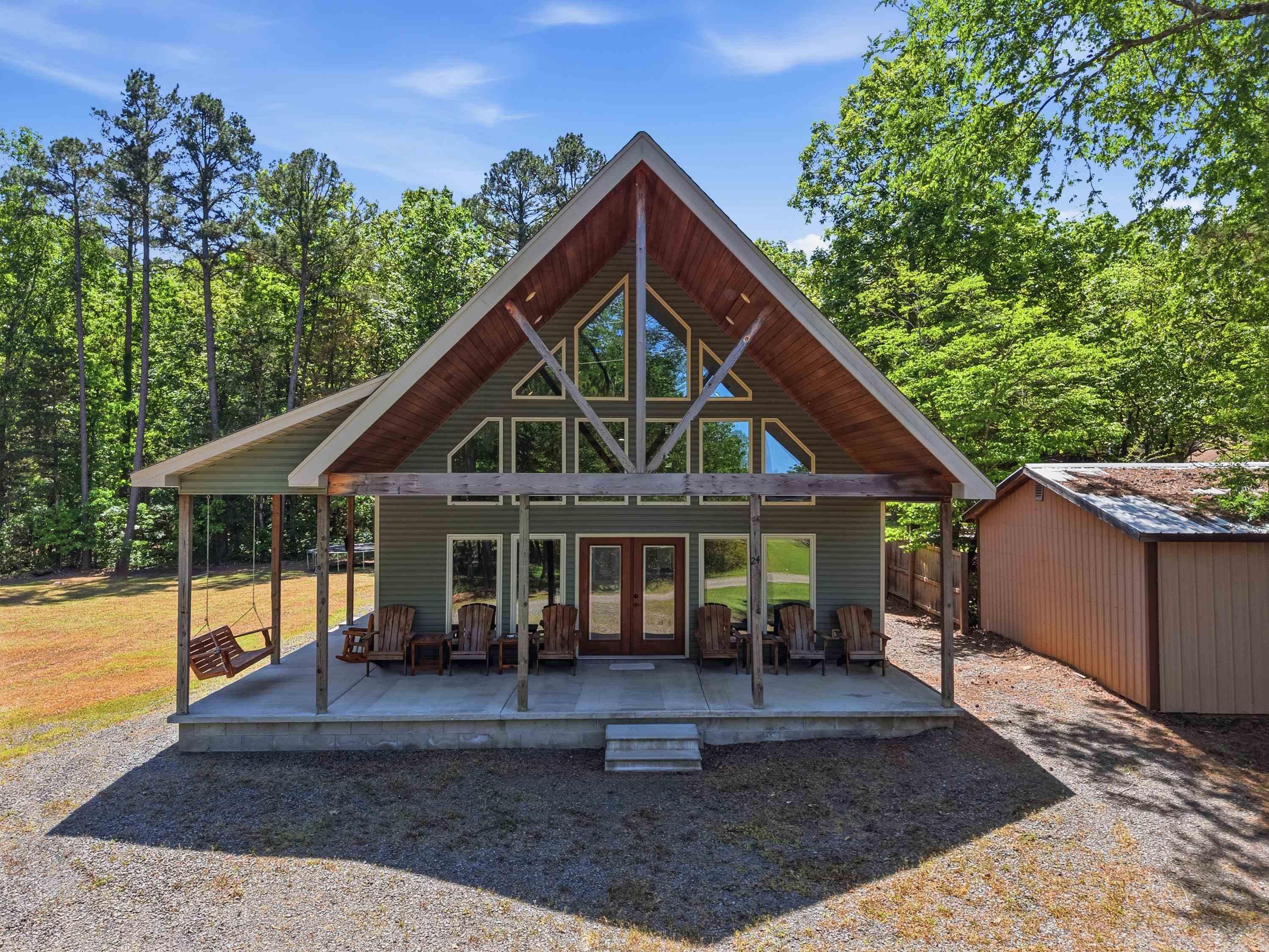 Come enjoy this spacious 3  bedroom Cabin just a short and easy 200' walk to the lake.  Featuring vaulted ceilings and stained concrete floors, this home is currently set up to sleep 12 guest.  Relax on the expansive wraparound porch that spans two sides of the cabin, offering plenty of space for outdoor entertaining and enjoying the peaceful surroundings.  (Measuring encouraged).