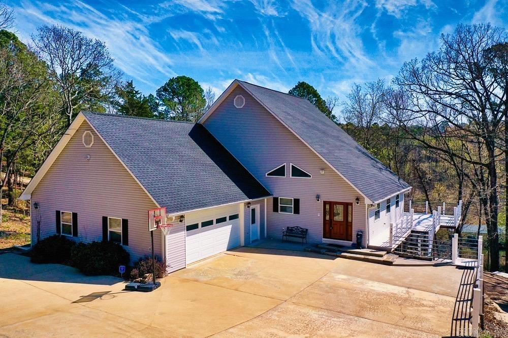 3,400+/- 4 BEDROOM, 3 BATH LAKEFRONT HOME WITH 2 BOAT SLIPS WITH LIFTS!! Wake up to year round lake views every day in this exceptional lakefront home located in Fairfield Bay. The home is designed to fully capture the beauty of lake living. Large windows and open living areas bring the outdoors in, creating a constant connection to the water that defines this property. From morning coffee time to sunlit water views during the day to peaceful evenings enjoying a meal overlooking the shoreline. What truly sets this home apart is the rare inclusion of two boat slips with lifts that are just an easy walk down from the house, giving you unmatched convenience on the lake. Whether you’re hosting family, entertaining guests, or simply enjoying the lake yourself, having two dedicated slips is a standout feature that’s hard to find with this kind of accessibility. Beyond the home, Fairfield Bay offers an incredible lineup of amenities, including three swimming pools, two 18-hole golf courses, hiking and biking trails, 90 +/- miles of ATV/UTV trails, pickleball courts, several great restaurants, tennis courts, and a full-service marina.  FURNITURE CONVEYS WITH PROPERTY, NEW ROOF JAN. 2026