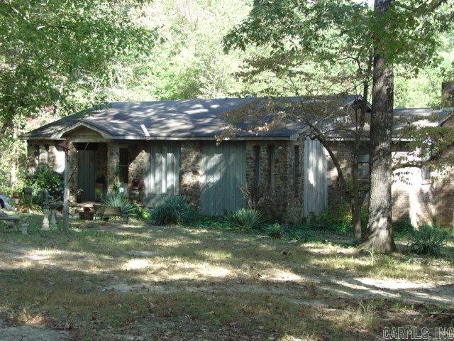 Cozy Country Home on 10-2/3 Acres .  3 BRs + bonus room, craft room, large laundry room & 750 SF basement with WBFP.  New Trane H/A system for great utility bills plus other updates. Garage plus 5 metal CP covers & other outbuildings.  Lots of wildlife - hunt on your own land.  City water & well, old orchard place & wet weather creek.  Will also sell home with  adjoining acre and one third.   Secluded yet only 8 min. from new outlet mall on I-30.