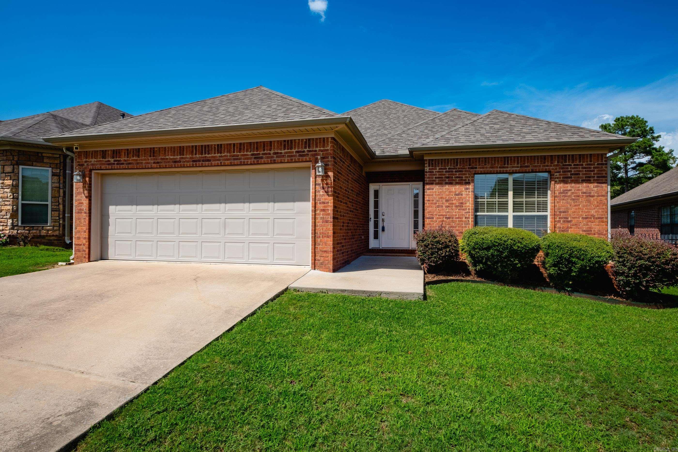 Welcome golfers! Pretty home with a great floorplan backing up to Country Club of AR golf course area. Walk in to gorgeous views and open floor plan which make this home an easy choice. A quick cart ride away to the range and first tee box! Interior has 9 & 10 ft ceilings, hardwoods in living & dining areas, fireplace in the living, open kitchen with corian counters, newer stainless steel appliances including a fridge plus a pantry, the spacious laundry room is off the kitchen.  3 bedrooms and the primary is HUGE w/ space for an office/sitting area, lots of windows overlooking the backyard and course views. Home is all brick, roof was replaced in 2024, HVAC in 2021, water heater in 2021, kitchen appliances replaced in 2025. Back patio extended, garage is oversized with an 18 ft door. This home is super clean and move-in ready.