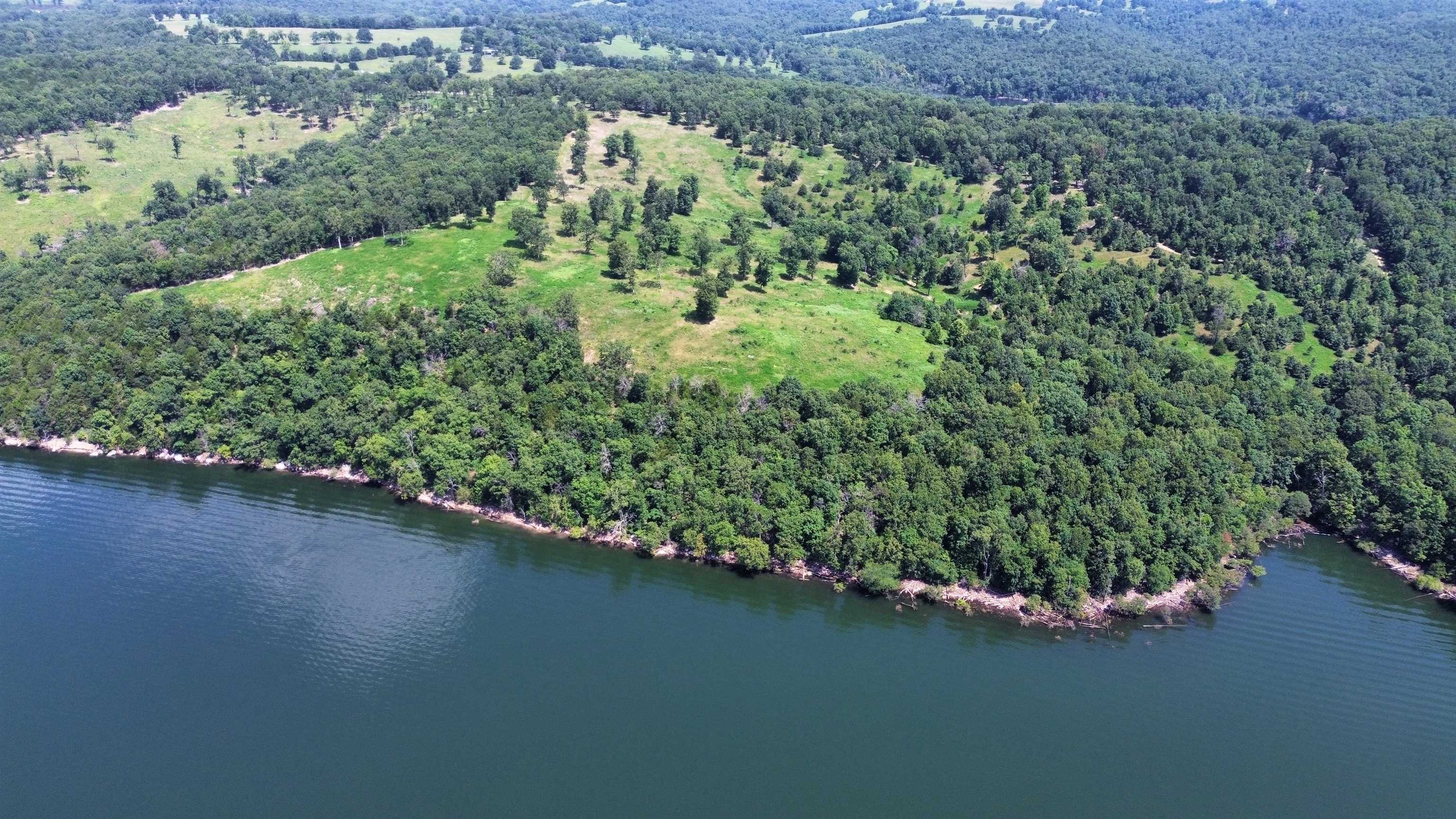 This is a rare opportunity to own a premier 120-acre lakefront property, nestled in the scenic Clark's Ridge area, just northwest of Mountain Home, Arkansas. Located at the end of a public road, this secluded property ensures ultimate privacy while delivering panoramic, million-dollar views of Lake Norfork. This stunning tract offers over 7,000 feet of boundary adjoining the U.S. Army Corps of Engineers’ wildlife management area, providing unmatched lake access and excellent hunting opportunities.  Whether you’re looking to build your dream home or invest in a unique recreational retreat, this property offers it all—including some of the most breathtaking vistas on the lake. Listed for $1,245,000.