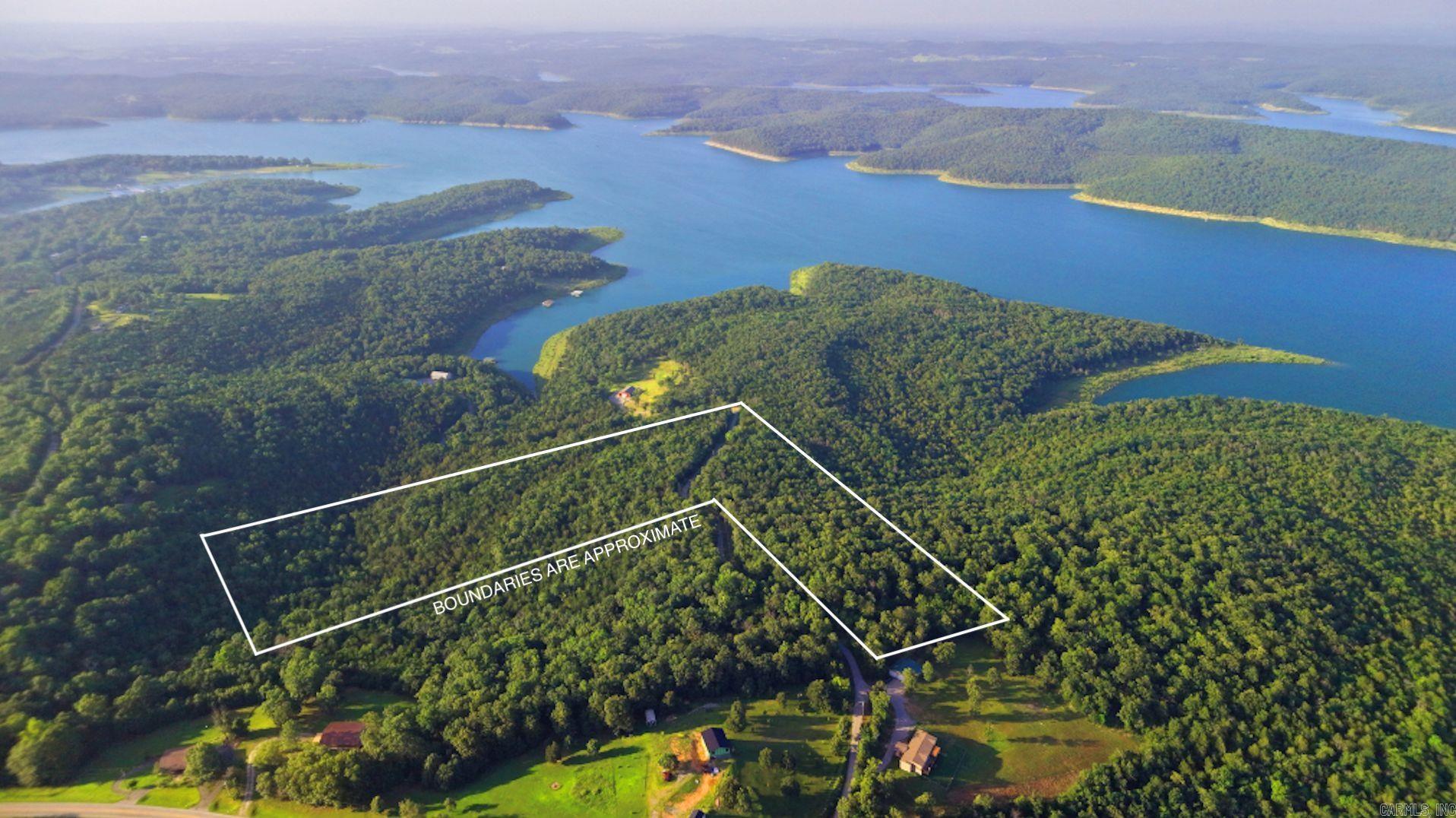 Welcome to your very own 25-acre tranquil retreat, where the beauty of nature surrounds you and the possibilities are endless. Nestled close to the majestic Bull Shoals Lake, this stunning wooded land offers a rare opportunity for those seeking a slice of country living without restrictions. Whether you dream of building your dream home, creating a weekend getaway, or simply enjoying a peaceful escape from the hustle and bustle of city life, this property is the perfect canvas for your vision.