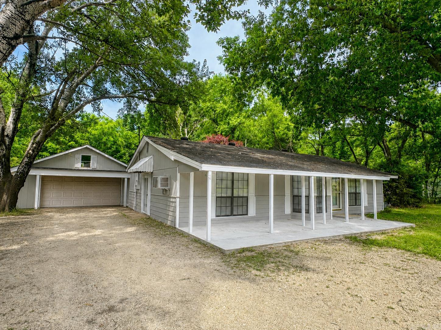 Looking for a peaceful place to call home in the heart of Jonesboro? Welcome to 1405 Granger Dr. Built in 1977, this charming home blends timeless original details with thoughtful updates, natural light, and great storage throughout. The flexible layout offers both a den and formal living room, with the formal living room featuring an en-suite walk-in closet, gas fireplace, and full bath with laundry area—making it a great option for a third bedroom, guest space, or office. Just 8 minutes from Arkansas State University, this property sits on over half an acre with mature shade trees, quiet neighbors, a partially fenced backyard, and a scenic wooded area beyond, giving it a peaceful country feel. Enjoy summer hummingbirds from the sunroom, cozy evenings by the fireplace, gardening, or working on projects in the storage buildings. No central HVAC currently, but the seller has received an estimate and is willing to have it installed with a full-price offer. A rare Jonesboro gem full of space, charm, and heart.