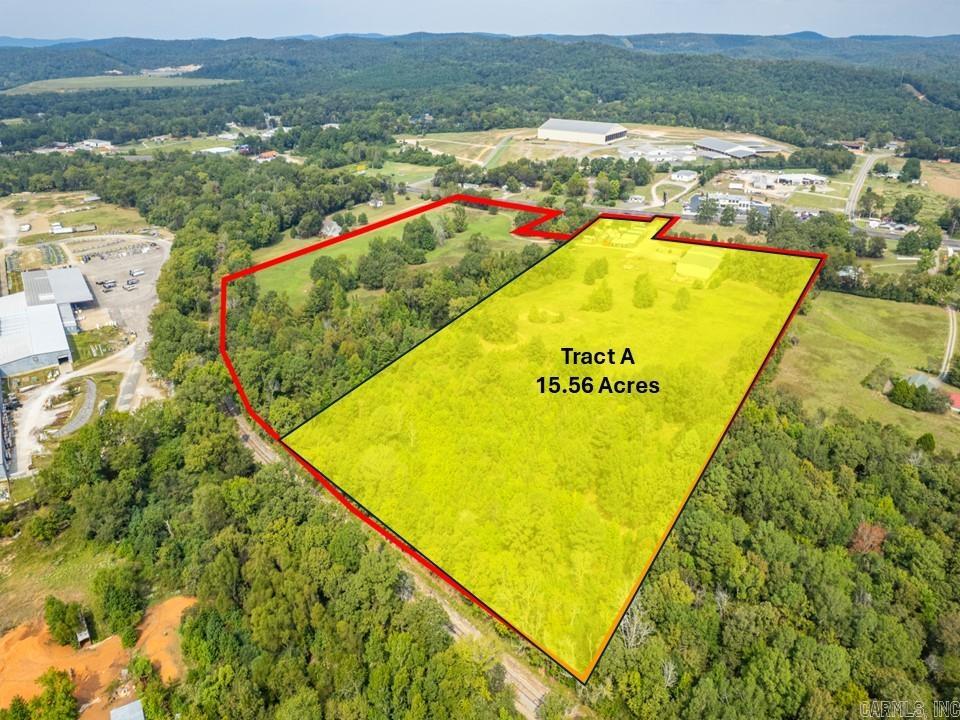 Position your business for success with this highly visible, income-producing commercial property located across highway 270E from the Garland County Fairgrounds. With exceptional highway frontage of 600 ft, flexible purchase options, and all city utilities on-site, this property is ideal for developers, owner-operators, or investors seeking immediate income and long-term growth.  Tract A features 15.56+ acres (all or part), 225 ft of HWY 270 frontage, a 10,727 SF building with a 5,000 sf shop/warehouse with four 14’x14’ overhead doors, 30’ ceilings, and 3 phase power. The balance of the building is 5,700 SF finished with a glass entrance, a showroom, spacious offices, and a private area with full kitchen and 1.5 bathrooms perfect for on-site management or additional rental income and is designed for versatility. This tract is currently income producing with a short term lease, providing immediate income with future flexibility.  *Adjacent 11.06+ Tract B and the residence located at 4838 Malvern Rd are also available for purchase by CBRPM.
