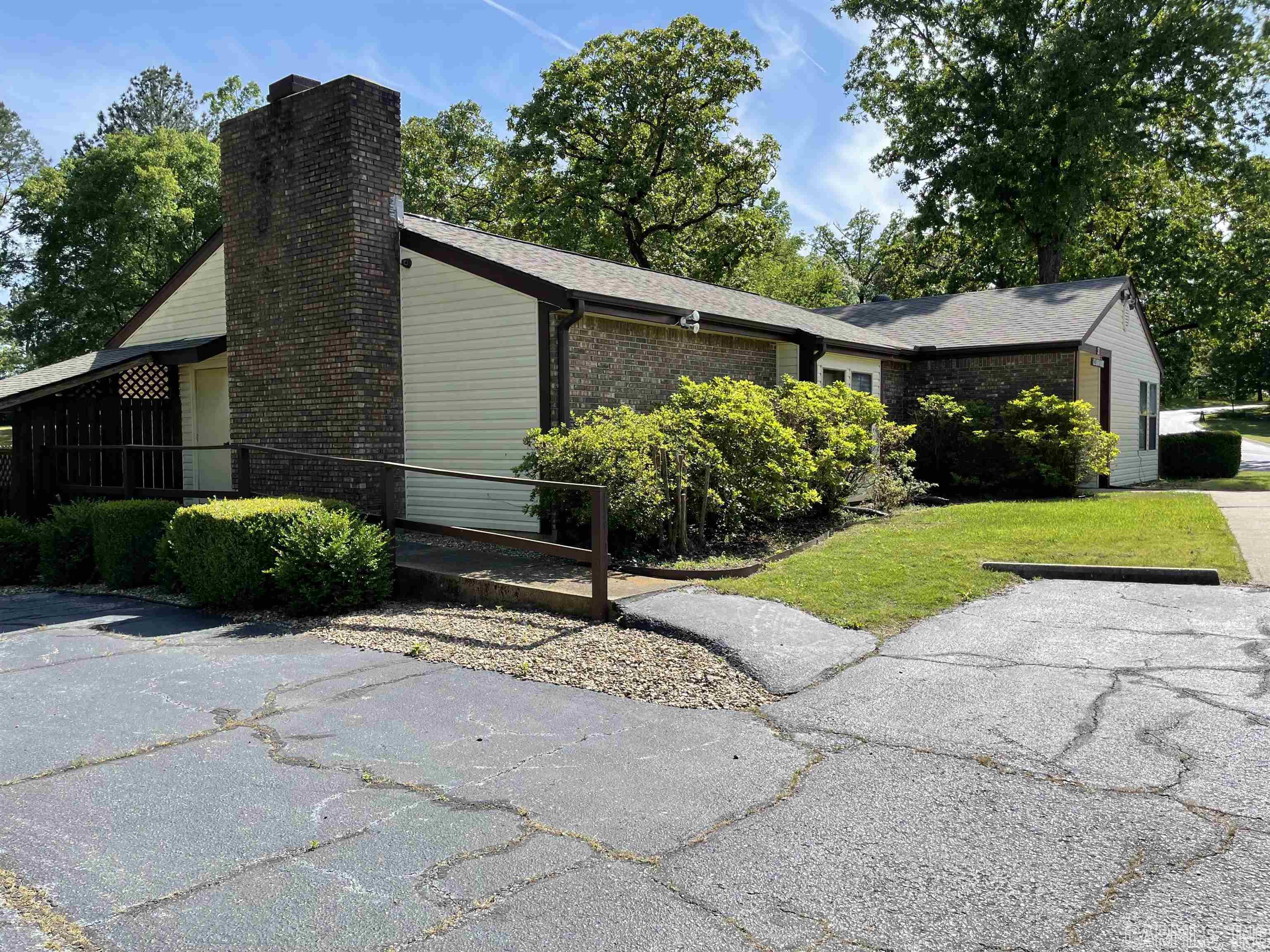 No steps! Level 3/2 on end in coveted Huntleigh Woods! New roof 2020, all trees recently trimmed.  Beautiful deck (there are steps here to go down to grass but you can go around!) Clean and within walking distance of the clubhouse where there are many activities as well as in ground pool and hot tub. Babbling creek in back and plenty of grassy areas if you have a furry friend! Large laundry room, Wood burning fireplace. Close to everything! Call me today!