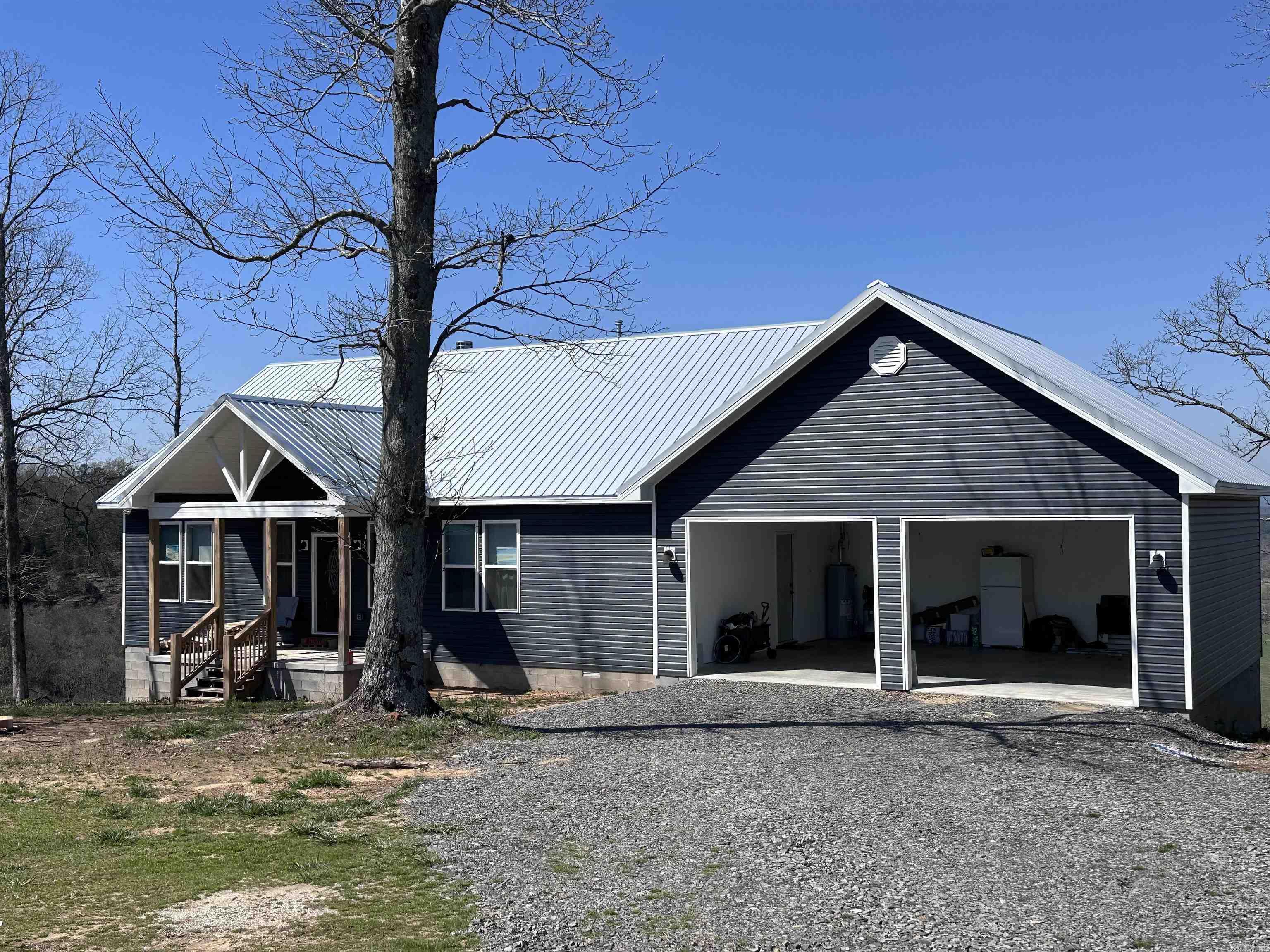 Brand new construction in 2023 all on 15.6 acres.  This home has a gorgeous view of the valley. The back deck is ideal to enjoy as you enjoy your morning coffee and evening sunsets. You will find 3 bedrooms on a split floor plan, 2.5 baths, open kitchen & living area with granite counters and wood burning fireplace.  Great home for entertaining. Also includes a walk out basement, storage building, barn and RV hookup.  If you are looking for peace and tranquility, this is the property for you!