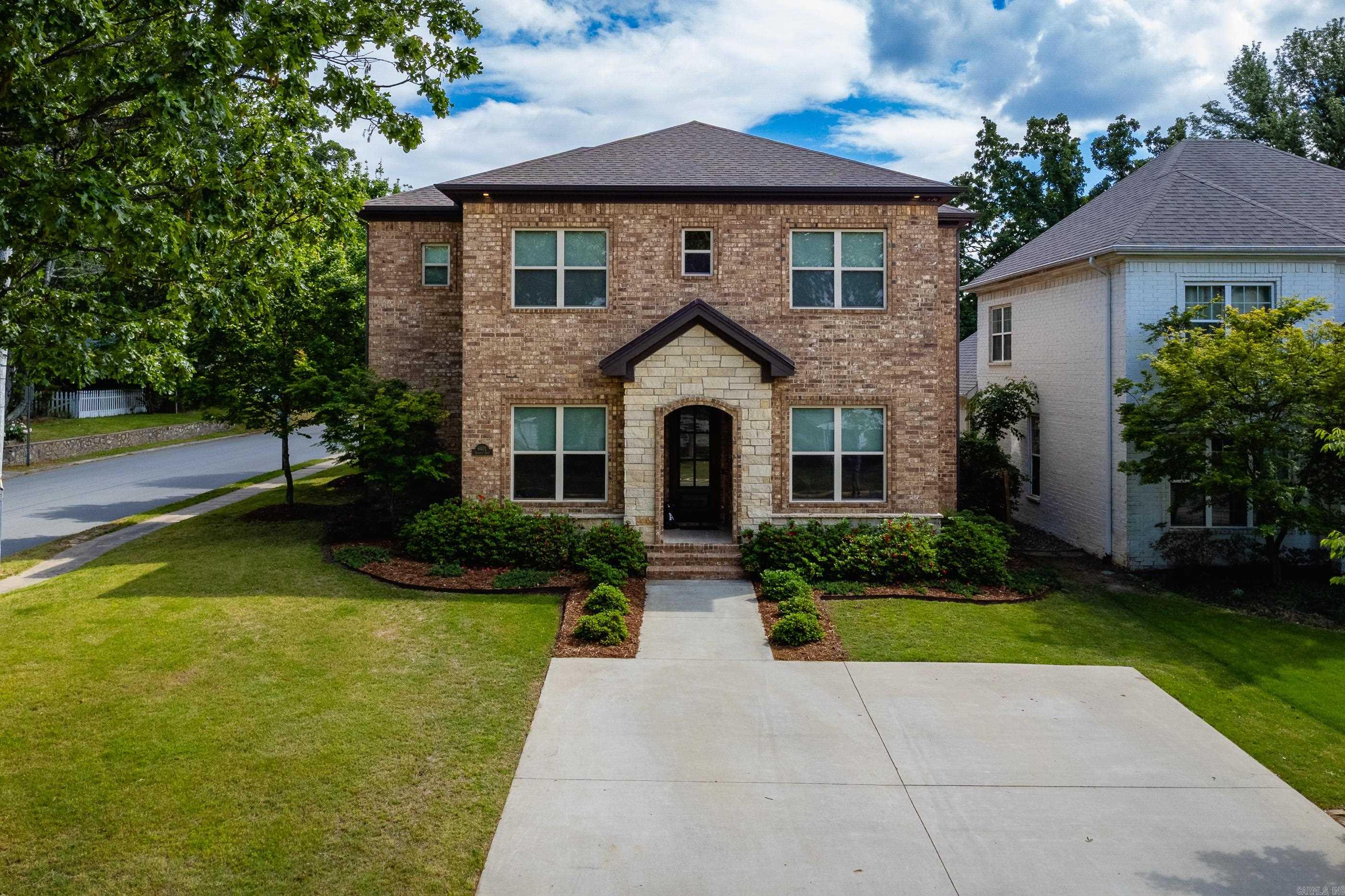 Beautifully newer home in the heart of Cammack Village offering the perfect blend of space, style, and location. Ideally situated near the neighborhood park, pool, police and fire departments, and elementary school, this home delivers an exceptional community lifestyle. The main level features a spacious primary suite, private office, formal dining room, and an expansive great room open to the chef’s kitchen with a huge island, gas range, and built-in refrigerator. Perfect for everyday living and entertaining. Step outside to the covered patio with outdoor fireplace overlooking the flat corner lot yard. Upstairs offers four additional bedrooms with two shared baths. Two-car garage heated/cooled.  Walk out attic storage.  Great opportunity in one of Central Arkansas’s most desirable neighborhoods.  Come see!
