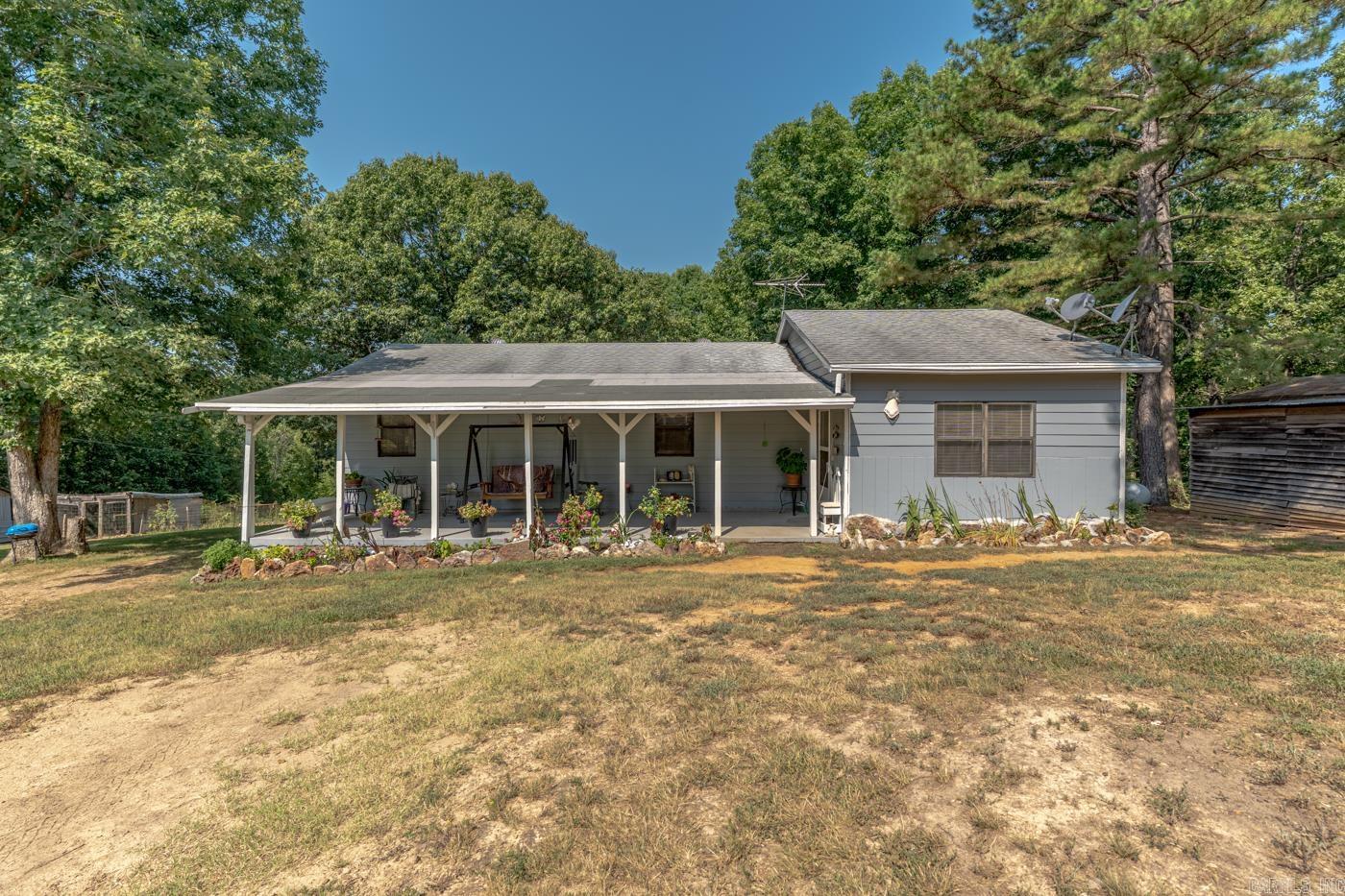 Welcome to Market 375 N Wilson Wells Rd. in Poughkeepsie, AR. Situated on 10 +/- acres across 2 parcels, this hunter’s paradise offers a private homesite, mature woods, open ground, abundant wildlife, and long-range countryside views. The 1,060 sf ranch is accented by stone, gutters, and a sprawling covered front porch overlooking the wooded setting. Inside are a living room, eat-in kitchen w/ gas range, dishwasher, built-in microwave, and window overlooking the property and wildlife, 2 bedrooms, 1 bath w/ shower/tub combo, and laundry room. Seller improvements include interior and exterior paint, gutters, HVAC, insulation, bathtub, landscaping, and land cleared for the yard. The mostly fenced property holds a 30x30 barn w/ loft and stalls, Bald Eagle Barn w/ lean-to, small storage building, chicken coop w/ fenced run, 250-gallon owned propane tank, and garden space. Wild turkey, bucks, does, squirrels, and rabbits are frequent visitors, while the acreage offers room for ATV riding. Public water, co-op electric, septic, and NEXT fiber internet serve the property. Located outside city limits near Hwy 56. Call today to make this house your home, mini-farm, or hunting retreat.