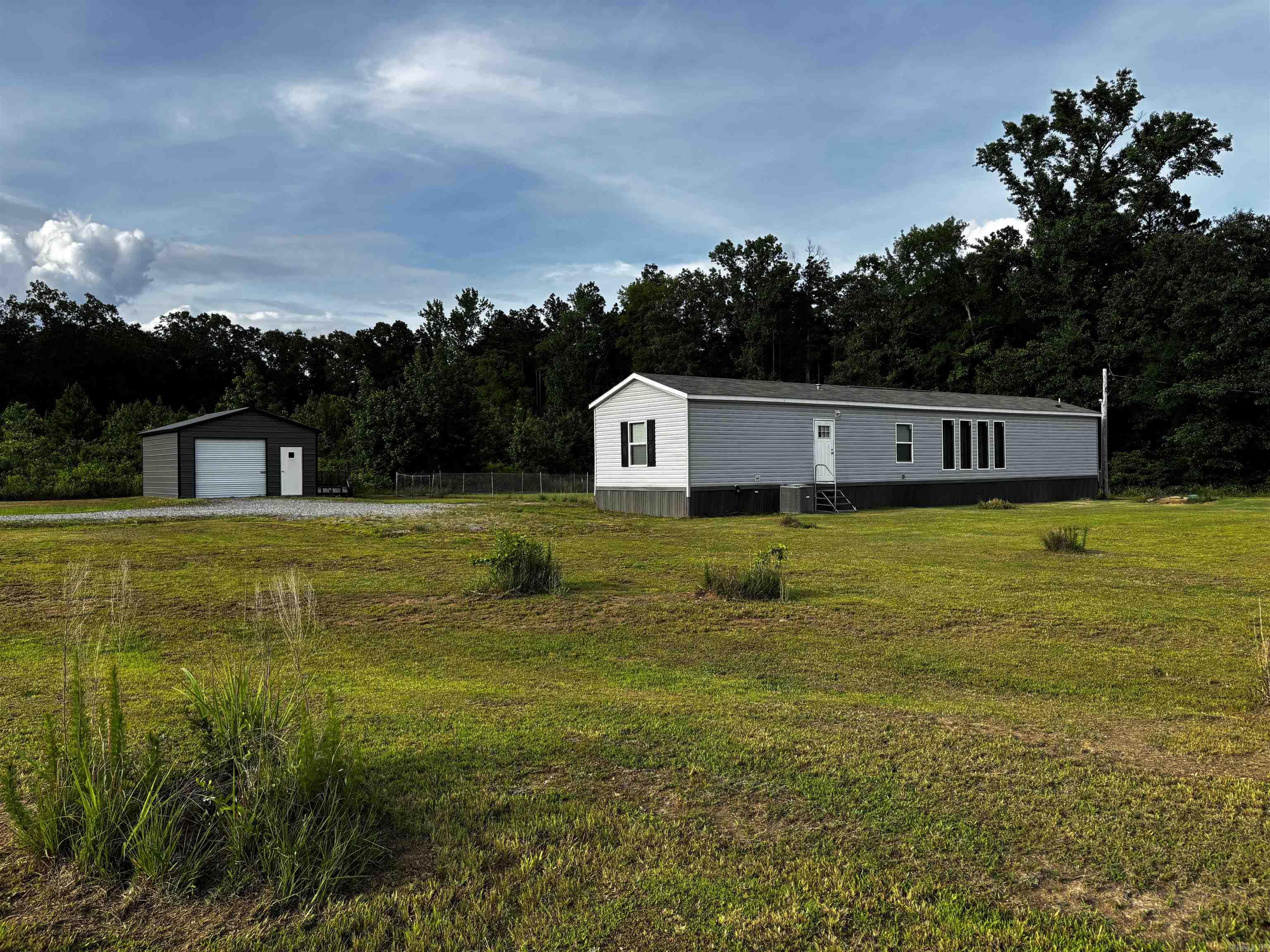 Escape to peaceful country living with this 2023 model mobile home situated on 7 beautiful acres. Offering 1,216 square feet, this well-maintained home features 3 bedrooms, 2 full bathrooms, an open-concept living and kitchen area, and modern finishes throughout. Enjoy the privacy and space of rural living while still having the convenience of a move-in ready home. The property also includes a spacious shop, perfect for storage, hobbies, equipment, or a workshop. Whether you’re looking for a homestead, starter home, or quiet retreat, this property offers endless possibilities.