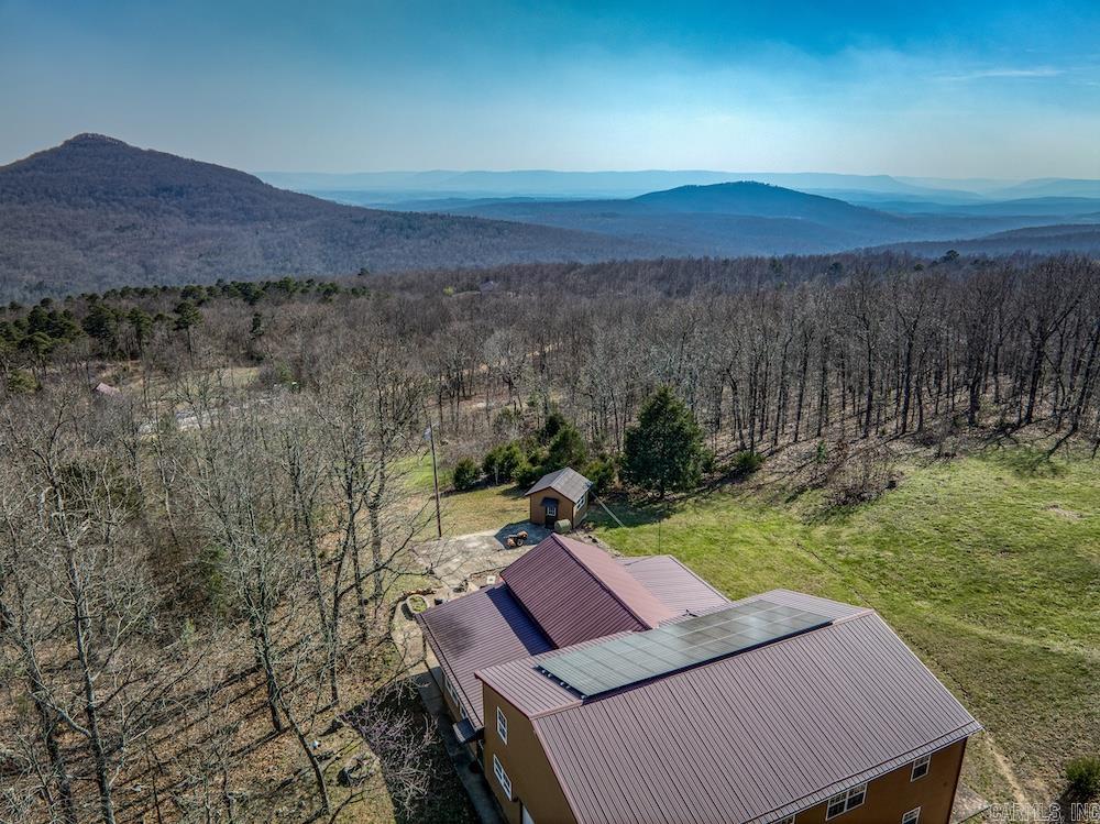 Hey folks, this one in Newton County, Arkansas, is something special. Whether you’re a growing family, homesteader, outdoorsman, or investor, this custom home offers space, efficiency, and Ozark independence with a metal roof, hardy board siding, and 36 solar panels. Inside, the main level features two living areas, formal dining, a galley kitchen with a large pantry, laundry with a full bath, and a spacious master suite. Upstairs offers another living area, a game room/office, four bedrooms, a full bath, a second laundry, and a bonus room, plenty of space for everyone. Outside, enjoy three large terraces with stunning Ozark views, raised garden beds, a garden shed with utilities, and an outdoor wood furnace. A 1,200 sq ft shop and a separate 750 sq ft shop add versatility. The private land is loaded with wildlife and features rolling terrain, rock outcroppings, and hardwoods. Located minutes from Harrison and near the Buffalo National River, this is a rare Ozark find.
