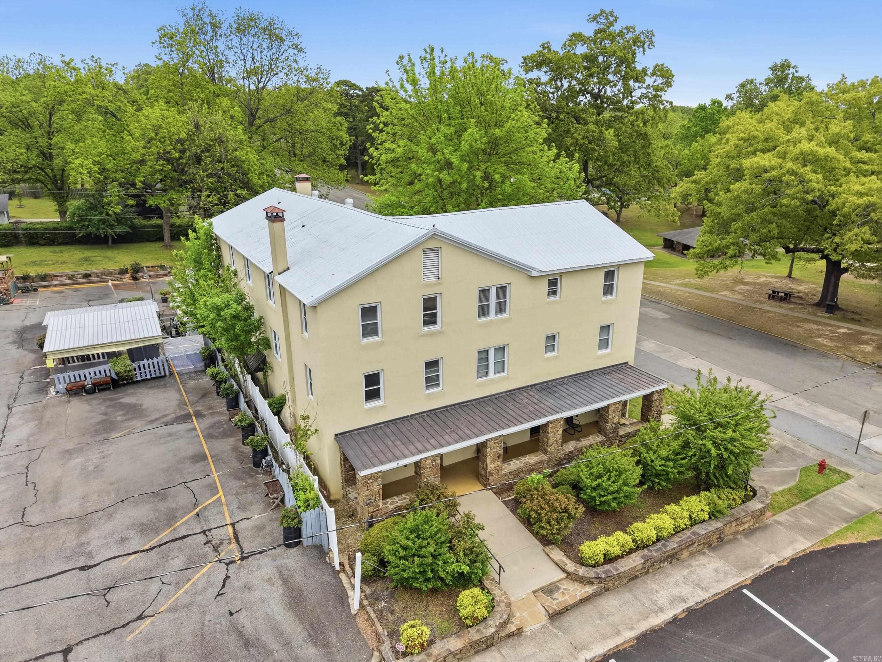 Enjoy downtown living in Heber Springs with this 3 story townhouse! Located on the corner of iconic Spring Park, SPM Unit D ground floor design includes living & dining areas, well appointed kitchen w copper pantry doors + brkfst bar & powder room. 2nd & 3rd floors each have private elevator & staircase access opening into the home's 3 bedrooms w fully renovated baths each w tile showers & floors. 3rd floor suite has spacious bath w tub + shower.  Details in this townhome include travertine tile and hardwood floors throughout + private elevator & extra wide staircases.  You'll also enjoy central heat and air supported by 2 HVAC units w climate controls on each floor ensuring year round comfort. Detached, assigned parking. With proximity to Greer's Ferry Lake, Little Red River, Eden Isle, and Sugarloaf Mountain, this thoughtfully renovated townhome is the perfect spot to enjoy all lake life has to offer including easy access to 3 golf courses, world class trout fishing, dining, shopping, & healthcare. Walking distance to cafes, boutique shopping, banking, & the Gem Theater.