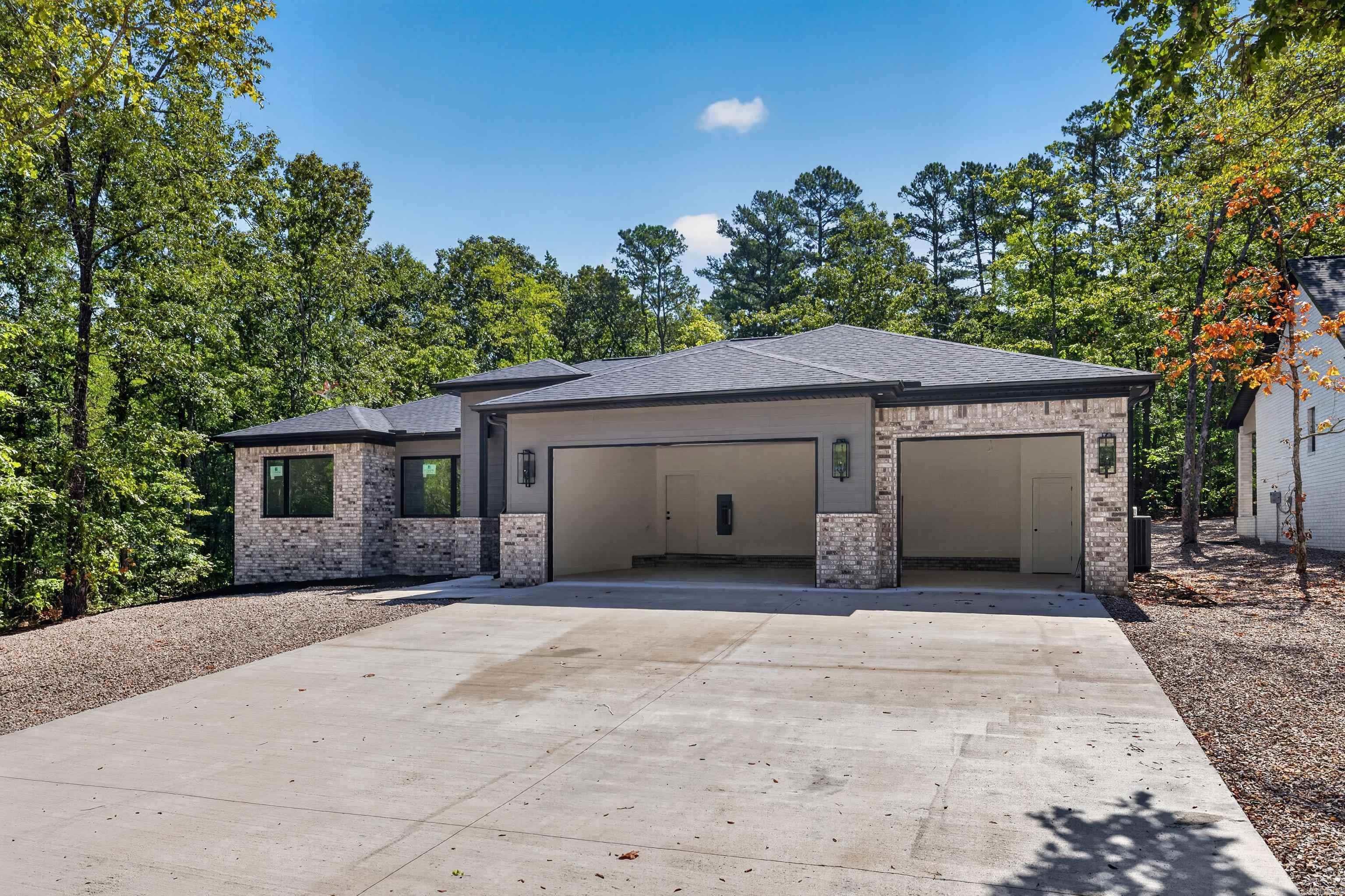 Stunning home backing to greenspace for ongoing privacy and beauty.. From the covered front porch to the patio expect nothing but excellence. Designer light fixtures and hardware throughout. In the kitchen you will enjoy upgraded stone counters and custom cabinetry including a well designed pantry with outlets. For the chef in the family there is a sought after gas stove with griddle. Note the oversized island perfect for entertaining. Great room features a stunning gas fireplace with surrounding cabinetry and shelving. The spacious primary suite has tray ceiling, oversized counter and large walk in shower, more than ample closet and laundry room access. This home has the can't live without 3 car garage!  Desirable Elite Home Builders new construction with exceptional quality and floorplans.  Come see our other new homes in this new hot subdivision just inside the GlaziePeau gate. Hot Springs Village is a 26,000-acre gated community with 11 lakes, 9 golf courses, white sand beach, hiking trails, pickle ball, fitness center, indoor and outdoor pool, tennis and SO MUCH MORE. One time POA buy-in fee $2000 due at closing. Taxes on vacant land. Pictures of similar homes by builder