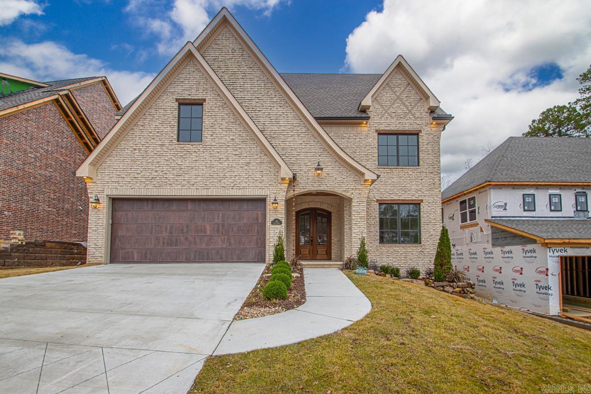 This custom-built French-style transitional home blends timeless elegance with modern comfort, offering 4 bedrooms, 4.5 baths, and a large media room (or 5th bedroom) with over 3,900 sqft in Chenal. Showcasing weeping mortar brickwork and high-end finishes throughout, the design is elevated by Sierra Pacific wood-clad windows that flood the home with natural light. The gourmet kitchen with a large pantry, two laundry rooms, and an extra-large bonus space provide both luxury and functionality. Dog lovers will enjoy dedicated indoor and outdoor bathing areas along with a secure built-in space for their pets. This home also features full insulation encapsulation and a 21 seer state of the art heating and air system. A quiet backyard with green space for relaxing or entertaining, and just minutes from shopping, dining, and Pinnacle Mountain, this home truly has it all.