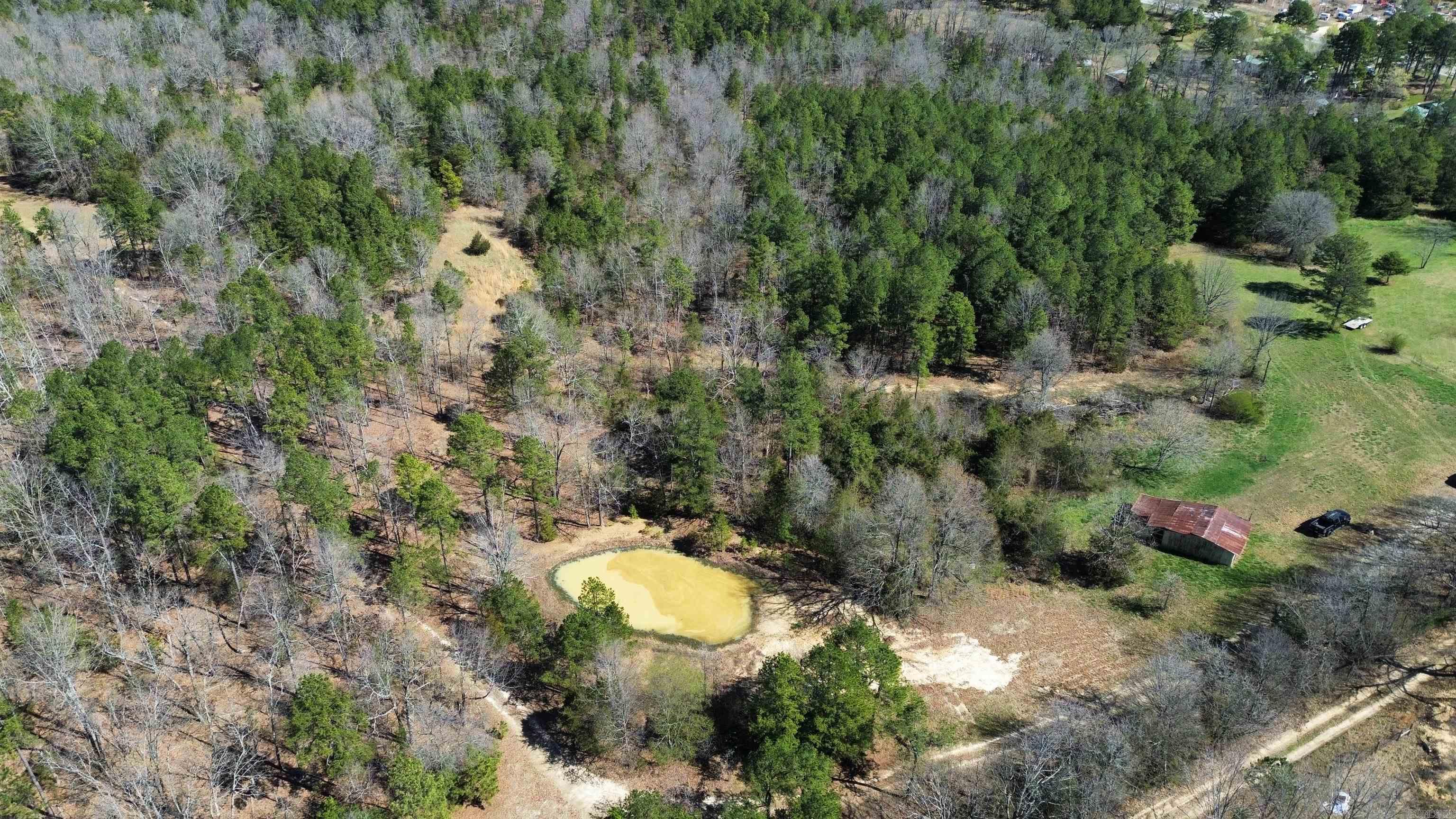 Nestled on 30.04 acres, this expansive property offers a picturesque blend of natural beauty and potential. Featuring a pond, diverse stretches of mixed pasture and timber, and abundant wildlife, it's an outdoor enthusiast's paradise and a hunter's dream. With no restrictions, the possibilities are endless—whether you're envisioning a peaceful homestead, a recreational haven, or a lucrative investment opportunity. Adding to its allure, an old barn stands. Plus, with electricity already available on-site, your vision for this landscape can easily come to life. Ready to escape the hustle and bustle and embrace the tranquility of country living? Don't miss out on this extraordinary opportunity. Listed for $99,900!