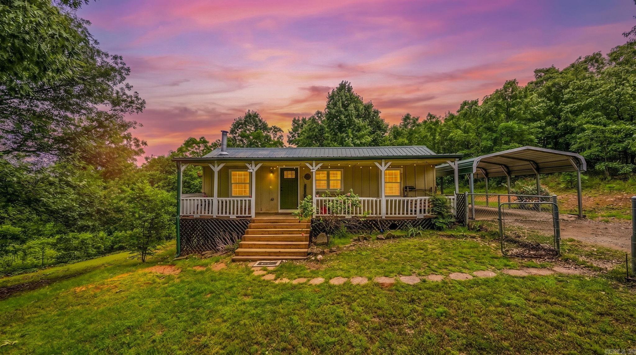Tucked away in a peaceful setting, this 2-bedroom, 1.5-bath home offers the perfect blend of charm, functionality, and natural beauty. With a thoughtfully designed split floor plan, the layout lives larger than its 864 sqft, creating a comfortable and efficient use of space. Inside, you’ll find an original fireplace that adds warmth and character, along with updated bathrooms that bring a fresh, modern touch. The kitchen is fully equipped with all appliances, including a recently added dishwasher for added convenience. Step outside and experience what truly sets this property apart—your own private oasis. Enjoy quiet mornings and relaxing evenings on the porch, taking in the beautiful views and stunning sunsets. The acreage includes a peaceful pond, adding to the serene atmosphere and making the outdoor space feel like a retreat. A covered carport provides additional functionality and protection from the elements. Whether you're looking for a full-time residence or a place to escape the noise, this property offers a rare combination of privacy, charm, and scenery—all just a short drive from Conway amenities!