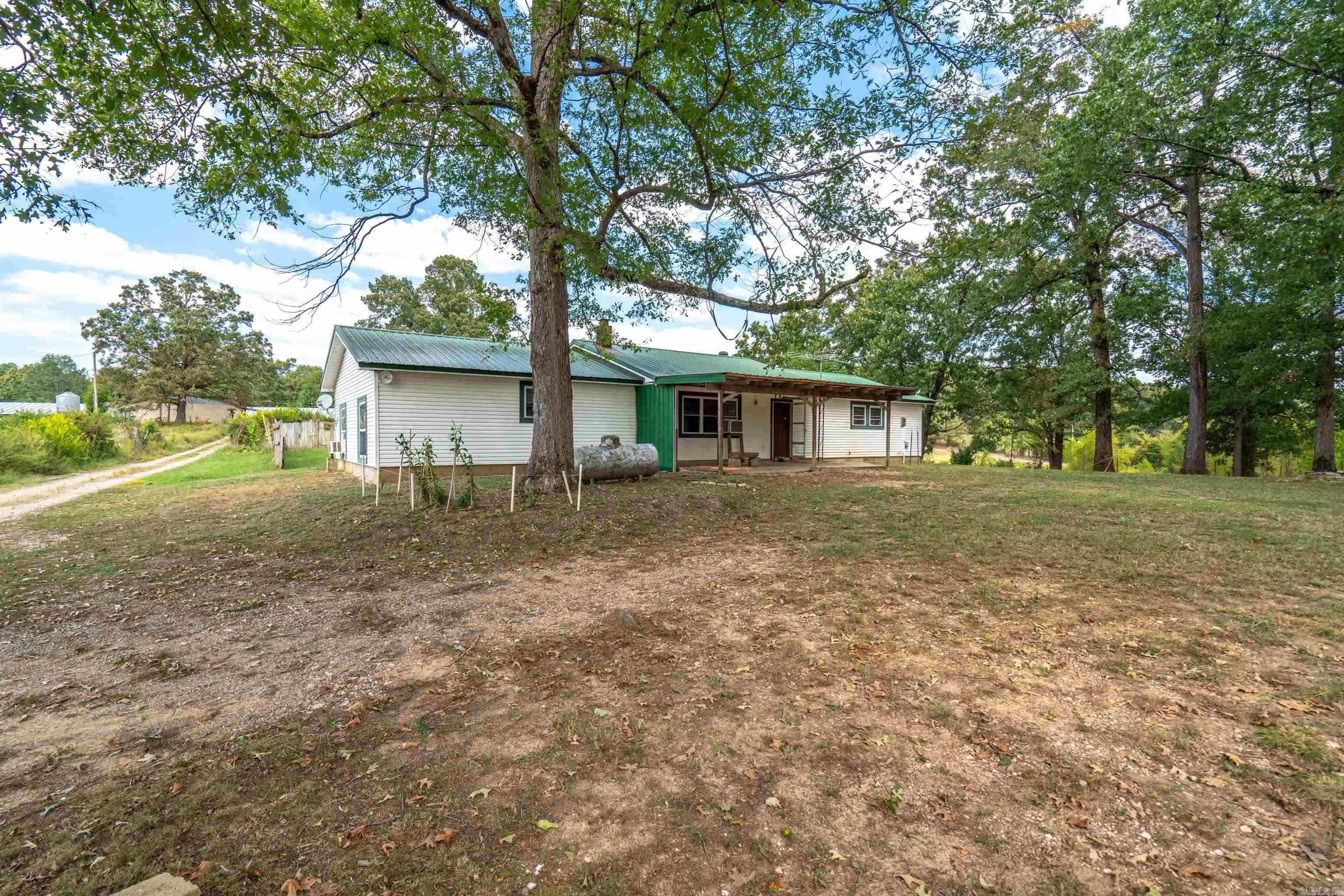 Welcome to the incredible N Miles Farm! This one-of-a-kind 40-acre property features beautiful rolling pastures, stocked fishing ponds, a charming treehouse, more than 20 peach trees, a thriving garden, and so much more.  The property includes a spacious 1,924 sq. ft. main home, a 1,600 sq. ft. duplex, a 644 sq. ft. mobile home, two retired 40' x 600' chicken houses (no longer in operation), a hay barn, an additional stall barn, a workshop/shop/garage, multiple industrial generators, and an impressive array of additional improvements.  With multiple residences and outbuildings, this property offers exceptional income-producing potential, whether you're looking for a family compound, rental opportunities, or a working farm. For added convenience, the local school bus picks up right at the front door.  Don't miss the opportunity to experience everything this remarkable property has to offer. Schedule your private tour today!  **Agents:** Please review the agent remarks for additional information.