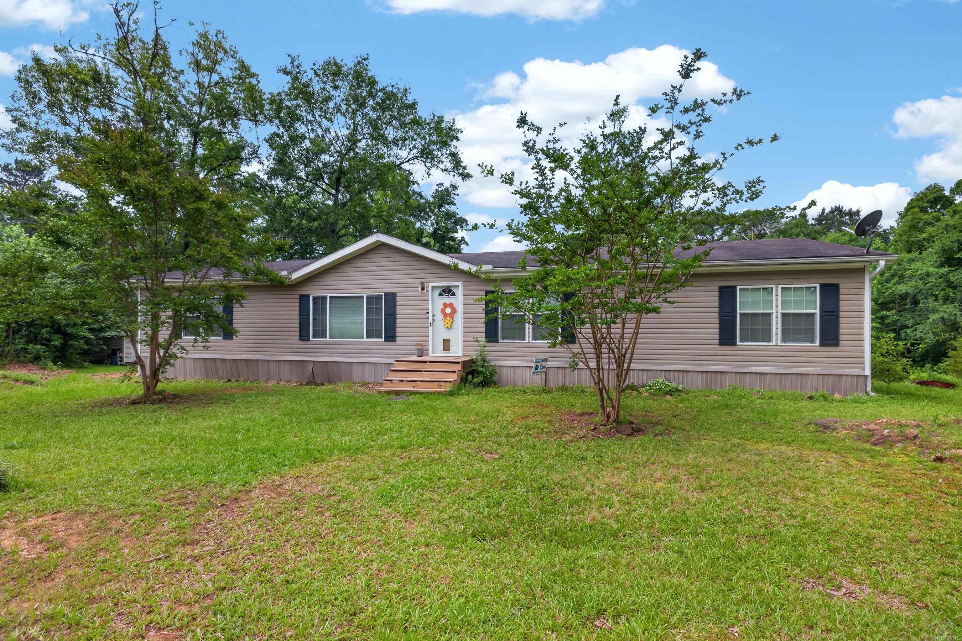 Welcome to country living in the desirable DeGray Community! Situated on approximately 4 acres, this spacious 3-bedroom, 2-bath double-wide home offers the perfect blend of comfort, functionality, and value. Built in 2008, the home features an open-concept floor plan with a large living area that flows seamlessly into the kitchen and dining space, making it ideal for everyday living and entertaining.  In addition to the main living area, you'll find a separate den that provides extra space for a family room, home office, playroom, or media room. The home offers an abundance of storage throughout, ensuring plenty of room for all your belongings.  Outside, enjoy the peace and privacy of acreage living with an outdoor storm shelter for added safety and peace of mind. Whether you're looking for room to garden, play, or simply enjoy the outdoors, this property provides endless possibilities.  Priced to sell, this property is a fantastic opportunity for buyers seeking space, convenience, and value in the DeGray area. Don't miss your chance to make this one your own!