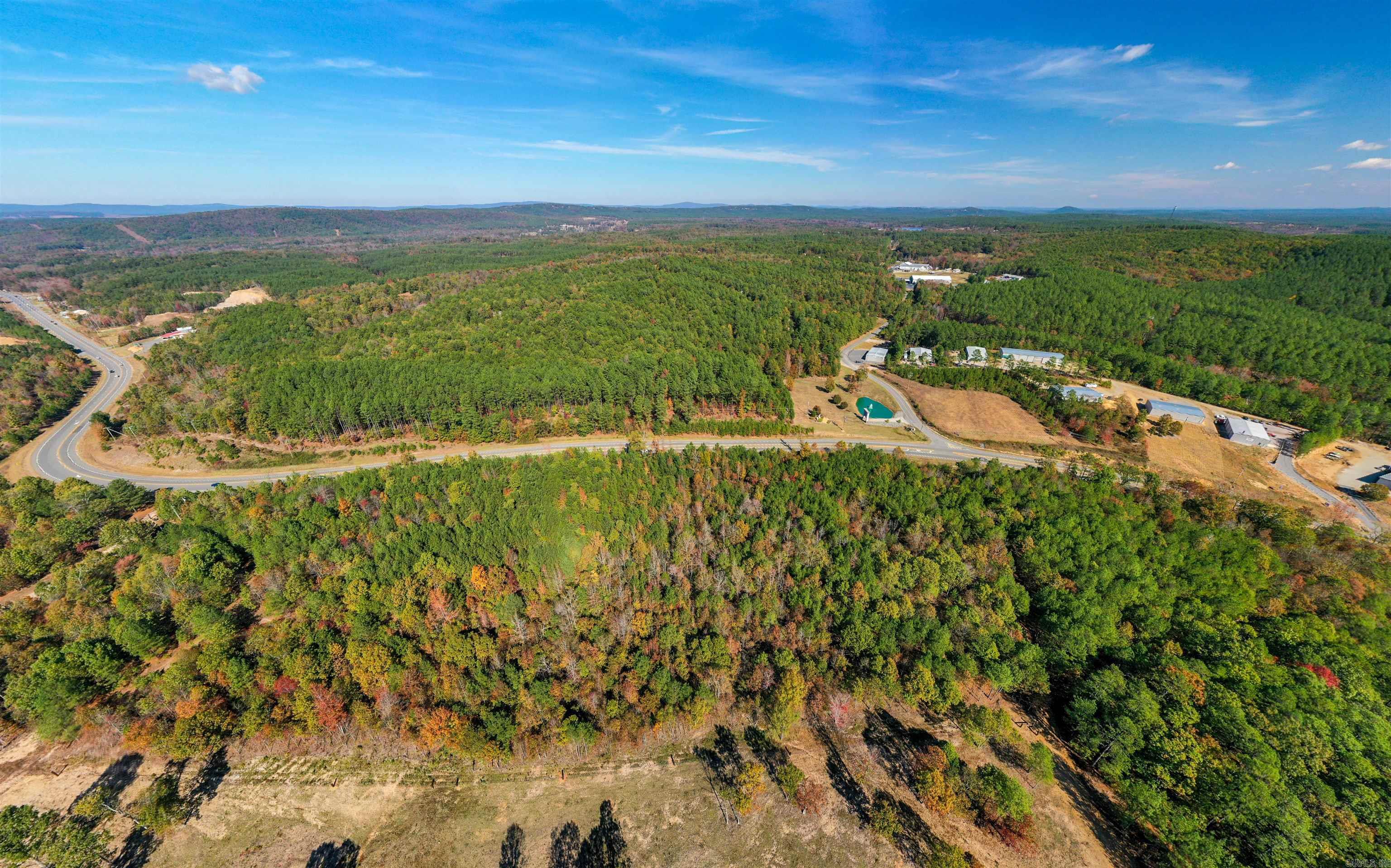 Discover an exceptional 5-acre opportunity on Scenic Highway 7, positioned in a high-traffic corridor near the highly sought-after Brookhill Ranch Road area. Featuring beautiful rolling hills, this versatile property is primed for commercial or residential development, offering outstanding visibility and accessibility for future growth. Ideally located for convenience, the property sits just minutes from local commerce, dining, and essential services. A nearby roundabout provides quick, direct access to historic Hot Springs, Oaklawn Racing Casino Resort, and the vibrant entertainment and shopping districts the region is known for. Travelers and commuters will appreciate being within easy reach of the Little Rock National Airport, making the location ideal for business or leisure. Surrounding amenities further elevate the appeal—Hot Springs Village, with its renowned golf courses, lakes, and outdoor recreation, is just a short drive away. Envisioning a premier subdivision, a thriving business location, or an investment with limitless potential? This unique 5-acre tract offers the rare combination of visibility, convenience, and natural Arkansas beauty. A total of 15 acres available.