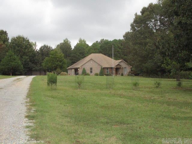 Charming and well-maintained 3-bedroom, 2-bath brick home offering comfort, convenience, and unique features throughout. Built 11 years ago, this home boasts durable tile flooring, a gas log fireplace in the living room, and a thoughtfully designed kitchen with an island/breakfast bar and undercabinet lighting.  Enjoy peace of mind with a whole-house surge protector, security system, and an in-house storm shelter equipped with electricity, internet, heating & air, and cable. Relax year-round in the enclosed sunroom or step outside to the covered porch overlooking the beautifully landscaped grounds.  The property also includes a spacious 24’x30’ shop with both overhead and walkthrough doors, plus a gas space heater and mini-split cooling—perfect for hobbies, storage, or a workspace. Outdoors, you’ll find a wooded park-like setting complete with a weather-proof lighted walkway, playhouse, tree swing, fire pit, fruit bushes, and pecan trees. This home truly combines modern comfort with outdoor charm, making it a perfect retreat for everyday living.