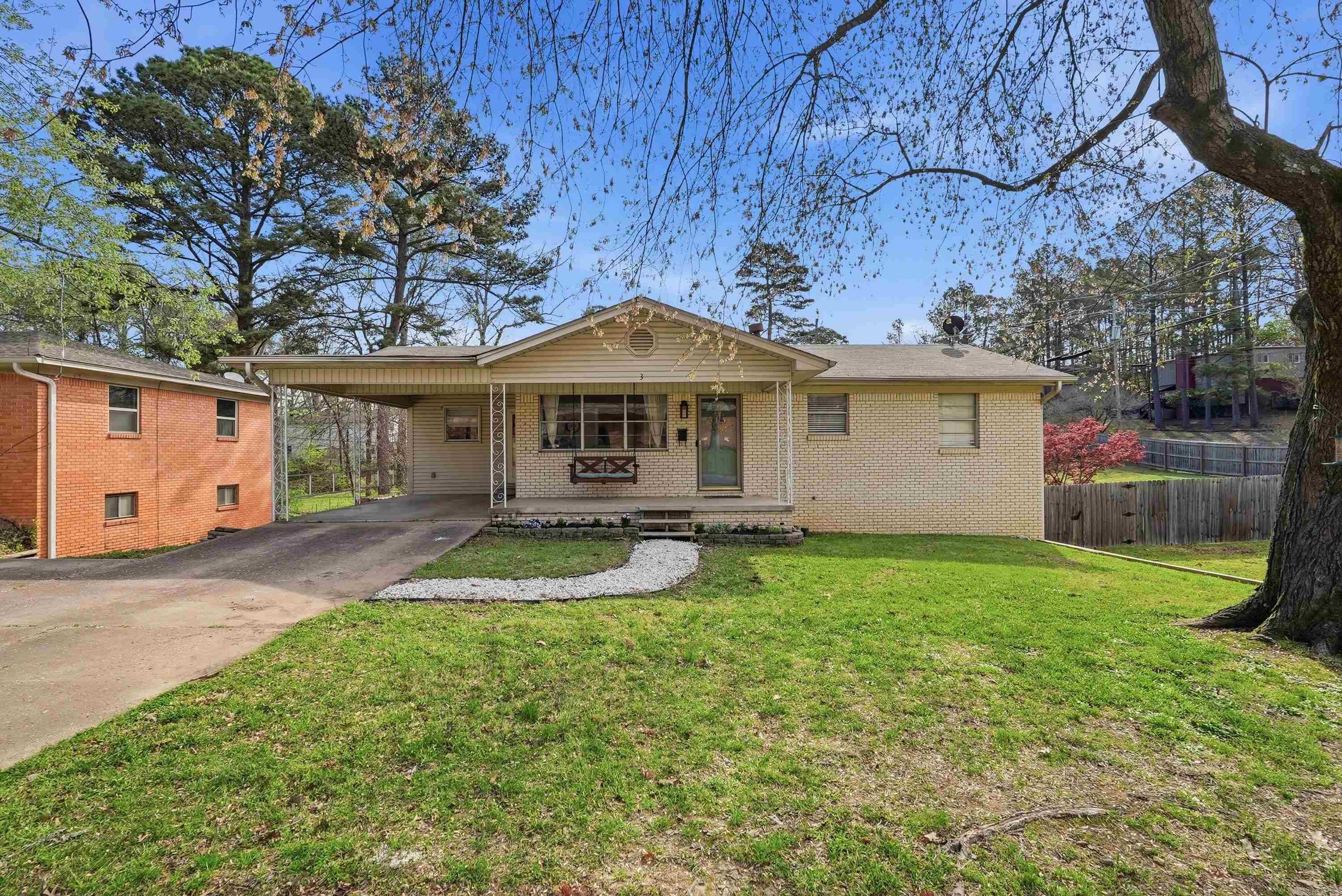 There are homes that feel lived-in in the best possible way — where the bones are solid, the character is real, and the layout actually works for the life you're building. 3 Birchwood Circle is that home. This 4-bed, 2-bath midcentury ranch on a cul-de-sac delivers all the space you need and more across two distinct living levels — each with its own personality. The main level is warm and grounded: original hardwoods, updated kitchen, and three guest bedrooms that share a full bath. Downstairs, the primary suite feels like a retreat — large walk-in closet, soaking tub, walk-in shower, and a second living space that flexes as an office, playroom, or family room. Outside, a double lot with a fully fenced, oversized backyard gives everyone room to breathe. Front porch. Back patio. Mature lot on a quiet cul-de-sac. Two minutes from Trader Joe's and Whole Foods. Easy I-630 access. This is West Little Rock at a price point that still makes sense — and a home that has room for everything your life is becoming.
