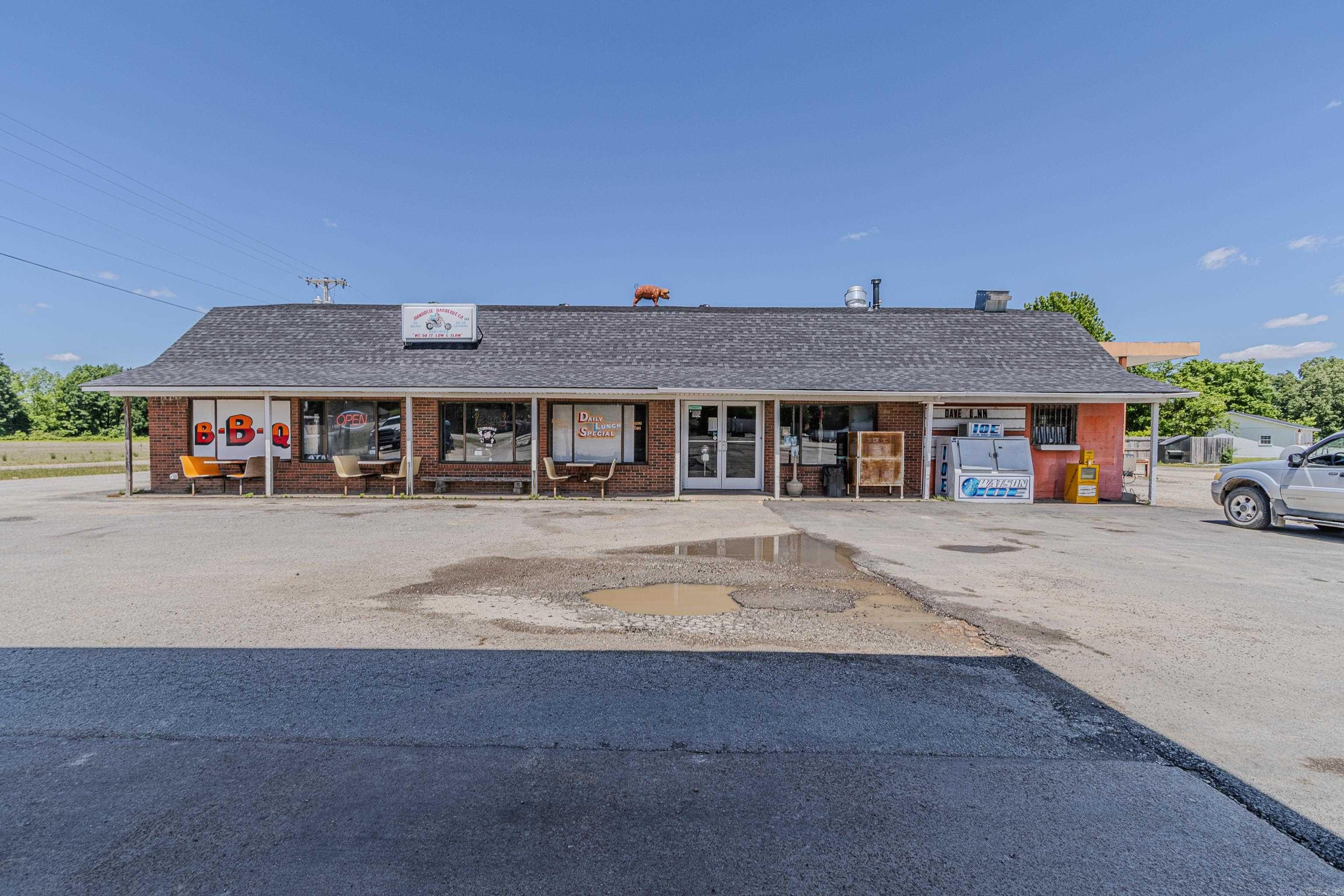Prime Highway Commercial Opportunity positioned along busy US Hwy 49N, the high visibility commercial property offers a rare, fully equipment investment opportunity in a high traffic corridor. Sitting on +/- 1.46 acres, the site is designed to support multiple revenue streams, including fuel sales, food service, retail and storage rentals. The 7,400 sqft main building features a well established convenience store with ample retail space alongside a full restaurant service. The restaurant is supported by a commercial-grade kitchen, detached smokehouse with a premium Ole Hickory EL-ED smoker powered by natural gas and wood-ideal for barbecue or high volume food operations. Fuel infrastructure is already in place including 3 underground storage tanks, 1 above ground farm diesel tank, and 1 above ground road diesel tank making this an excellent set up for both consumer and commercial fueling needs. Additional income potential comes from 5 onsite storage units and a 30x50 metal storage building built in 2019 adding even more flexibility operations or leasing. Major updates include roof approx 1 year, HVAC approx 5 years providing peace of mind for future ownership. See agent remarks