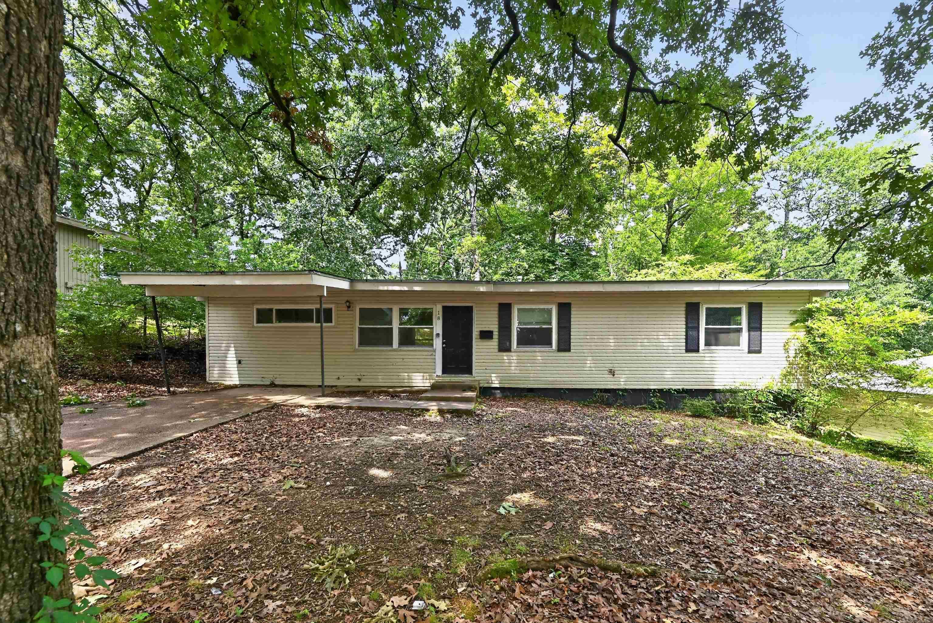Single-story conventional ranch residence situated in the established 65th Street West neighborhood corridor of Little Rock. This residence provides a functional main-level footprint encompassing approximately 1,300 to 1,452 square feet of finished living space, including 3 bedrooms and up to 2 bathrooms. The interior layout features a primary living area with an integrated fireplace asset, hardwood flooring elements, and an adjacent kitchen configuration with dedicated utility connections. Structural attributes feature a traditional wood-frame exterior with vinyl and metal siding components on an established foundation setup with a composition shingle roof line. The exterior incorporates a level 0.21-acre lot profile featuring open rear lawn space and off-street driveway parking capacity. Conveniently positioned with straightforward proximity to baseline transit routes, local public schools, neighborhood park facilities, and regional commerce hubs.