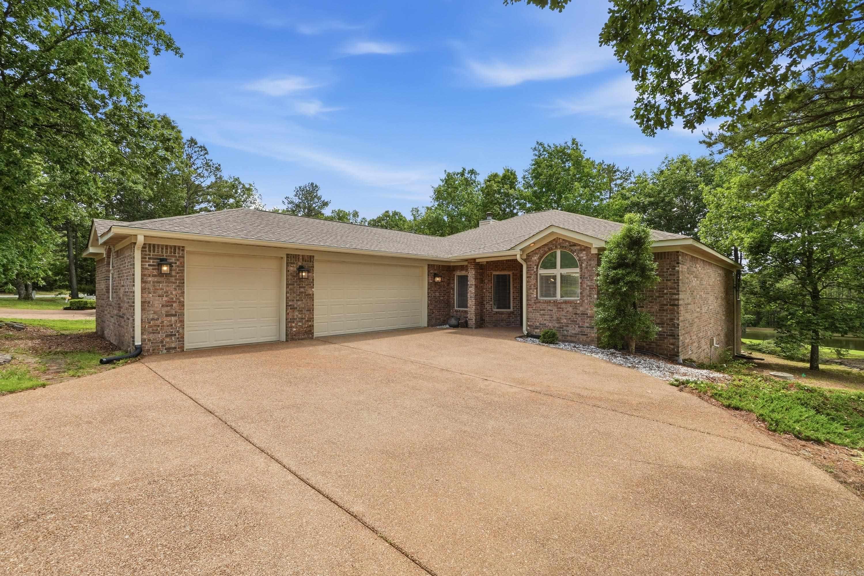 Welcome to your dream home on Mountain Ranch Golf Course! Nestled in a picturesque setting, this custom-built residence is a true gem. A new heat & air unit has been installed as well as updated bathrooms, carpet & tile & paint throughout. A new gas cookstove was recently installed. Prepare to be captivated by the breathtaking views of Fairway 2, offering a serene backdrop of water that will surely leave you in awe. Soak in the tranquility of your surroundings. Whether you're enjoying morning coffee or hosting gatherings with loved ones, this outdoor oasis is sure to impress. Inside, the allure continues with a beautifully appointed kitchen featuring custom cabinets & elegant granite The vaulted ceiling in the living room, adorned with wood flooring & a cozy fireplace, creates a warm & inviting atmosphere perfect for relaxation or entertaining. With a spacious 3 car garage & additional golf cart garage below, storage will never be an issue. The split floor plan offers privacy & convenience, making this home ideal for families or those seeking a peaceful retreat. Wrapped in a timeless brick exterior, this residence exudes charm & sophistication. Some photos have been virtually stage