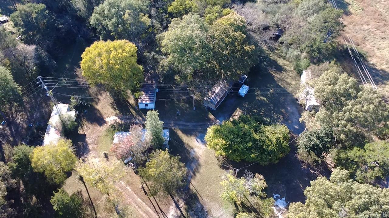 This 10-acre property in Hatfield, Arkansas, is an existing mobile home park with excellent potential for future income. It currently includes 10 mobile home hookups, each equipped with its own electric meter, city water, and sewer connection. The section where the hookups are located is cleared, while the back portion of the property is wooded, offering a mix of open space and natural privacy. There are currently five mobile homes on the property that will need to be repaired or removed, allowing flexibility for new development or improvements. A legal easement runs along the right side of the property up Rowe Lane, providing access to the neighboring property. This property sits just outside of city limits, offering more flexibility while still being conveniently located. With existing infrastructure in place, this is a great opportunity for someone looking to create or expand an investment property. A layout of the property is included in the listing photos, showing the location of all hookups, the existing mobile homes, and the easement.