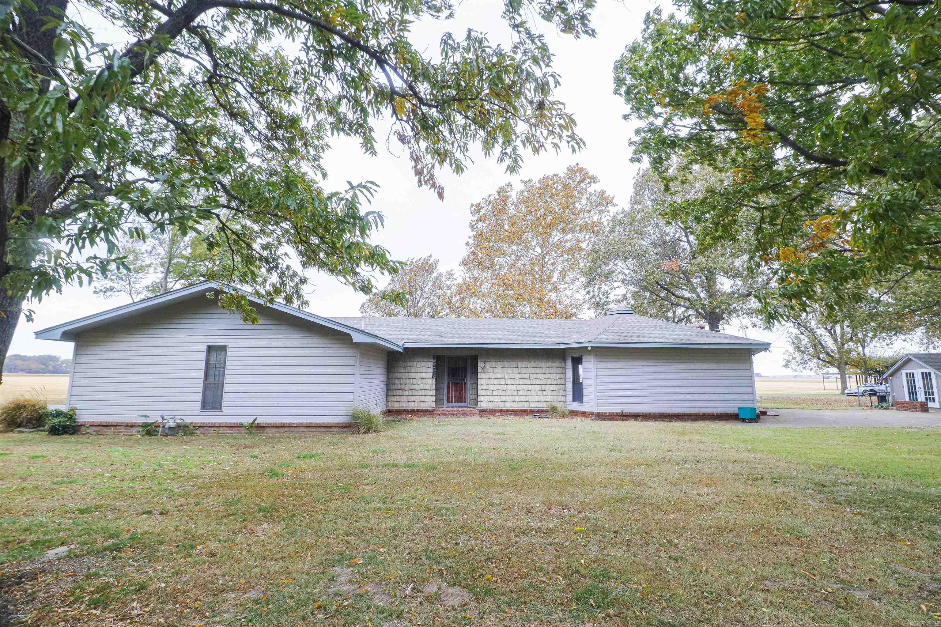 This lovely home is full of character and charm and ready for the next owners. The custom built, one owner home has been well cared for and maintained. The open concept living/dining/kitchen makes this a wonderful place to entertain and have room for everyone. There is also room for privacy with 3 large bedrooms that have their own outside exit. There are 3 full baths as well as a dedicated laundry room, a den or office with additional fireplace and many closets for spacious storage. Mature trees frame the 2.79 acre property that has an asphalt circle drive, oversized garage, with additional motorcycle or golf cart garage. Property has a large shop for working or storing equipment, or collectable vehicles. There is also a pole barn for additional covering. If space (2780 square feet), a peaceful setting and proximity to the city are what you are looking for, Call today to schedule a private tour of this beautiful property.